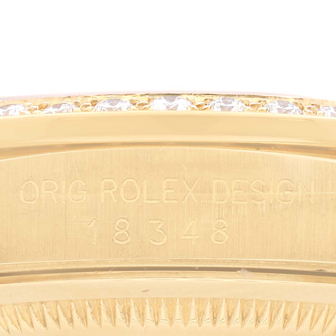 This close-up shows the engraved side of the Rolex President 18348 Men
s Yellow Gold Champagne Dial 18348 Men
s Yellow Gold Champagne Dial model 18348 with diamond detailing on the bezel.