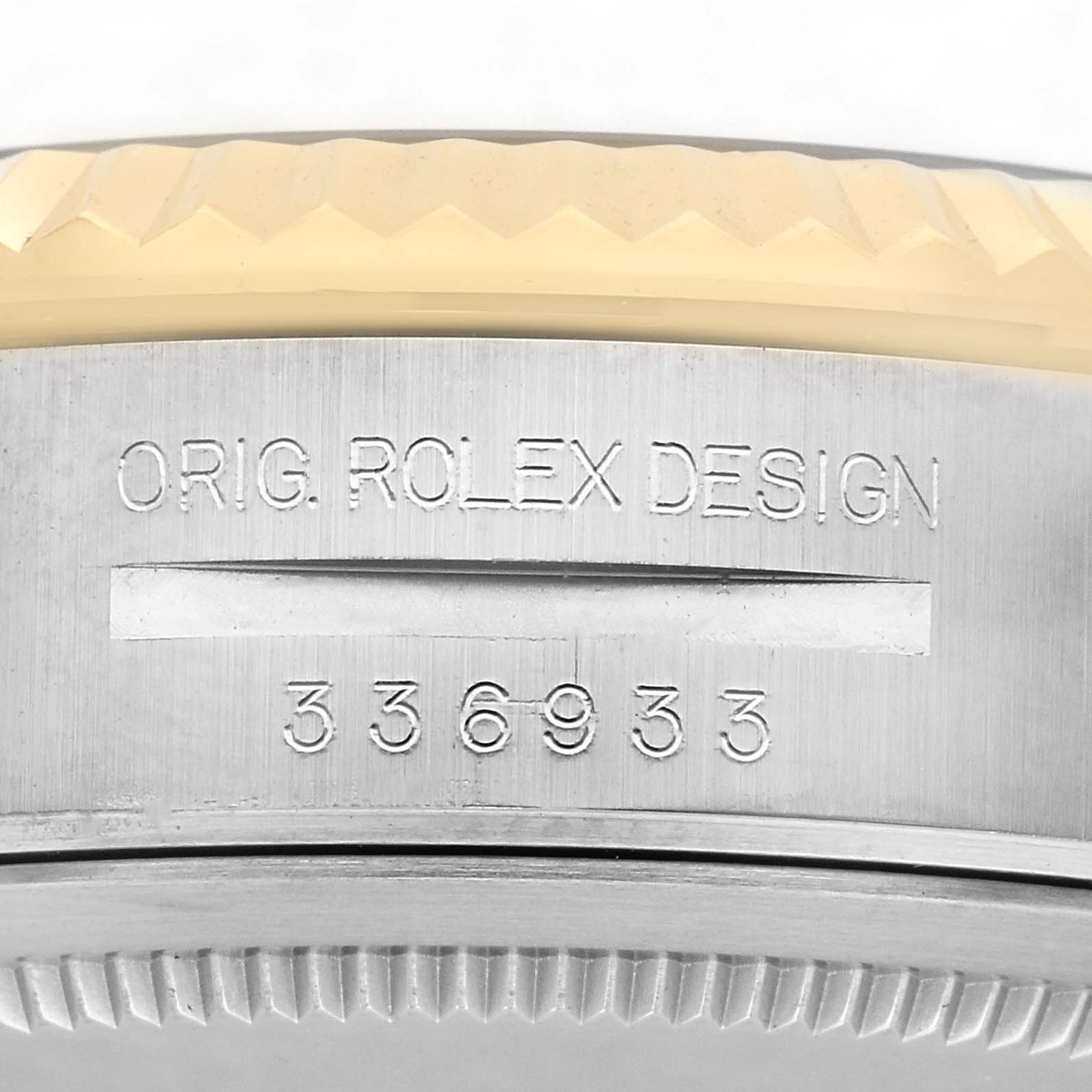 The image shows a close-up of the side casing and bezel of a Rolex Sky-Dweller 336933 Men's Steel and Gold (two tone) Silver Dial 336933 Men's Steel and Gold (two tone) Silver Dial, highlighting the engraved design and model number.