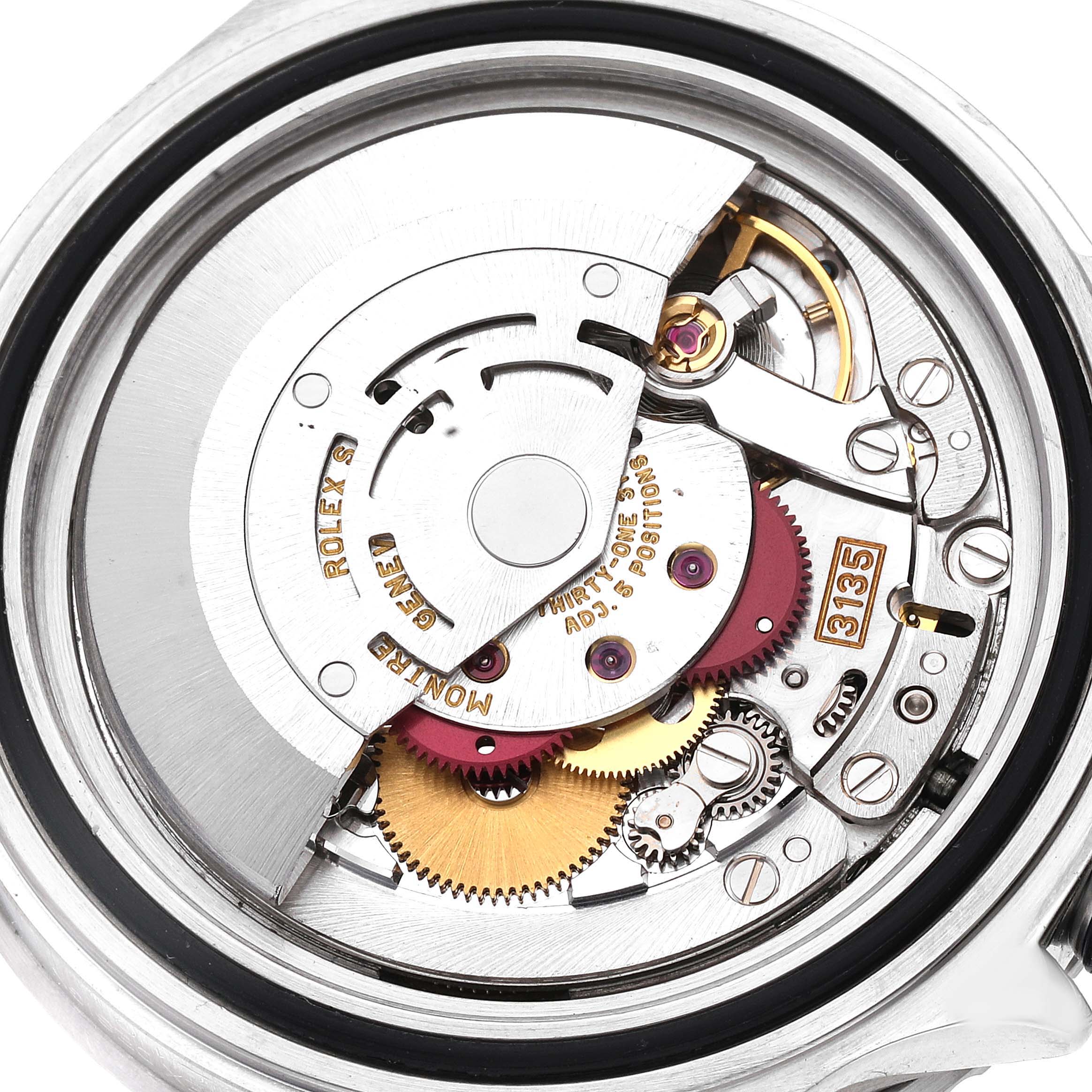 This image shows a close-up of the internal movement parts of a Rolex Submariner 16610 Men
s Stainless Steel Black Dial 16610 Men
s Stainless Steel Black Dial watch, highlighting the intricate gears and mechanisms.
