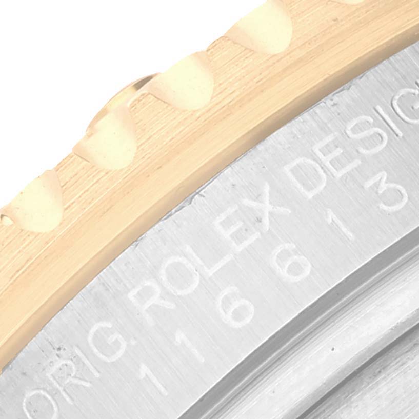 The image shows a close-up of the bezel and engraved case of a Rolex Submariner 116613 Men
s Steel and Gold (two tone) Blue Dial 116613 Men
s Steel and Gold (two tone) Blue Dial watch.