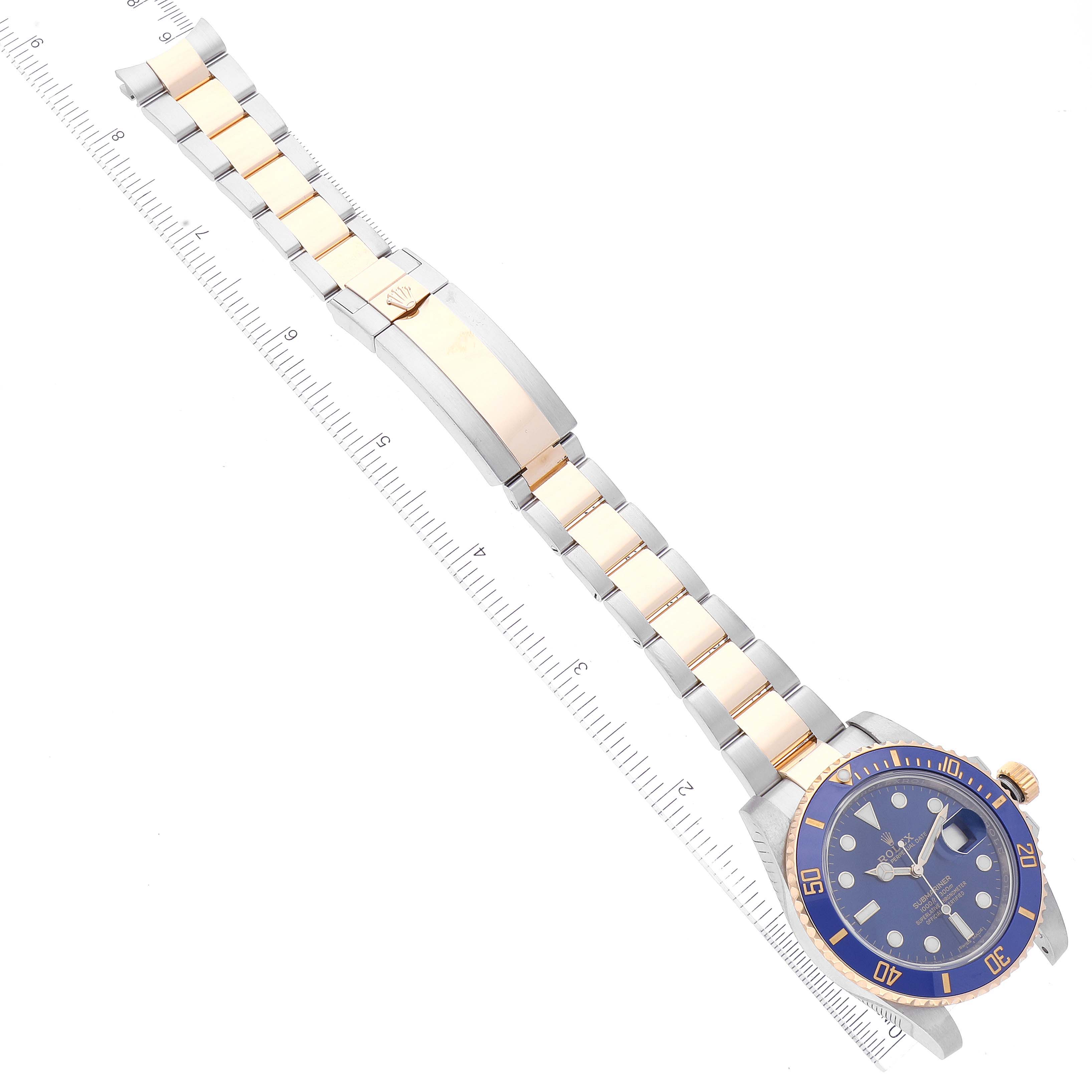 The image shows an overhead view of the Rolex Submariner 116613 Men
s Steel and Gold (two tone) Blue Dial 116613 Men
s Steel and Gold (two tone) Blue Dial watch, featuring its face, bezel, and two-tone bracelet with clasp.