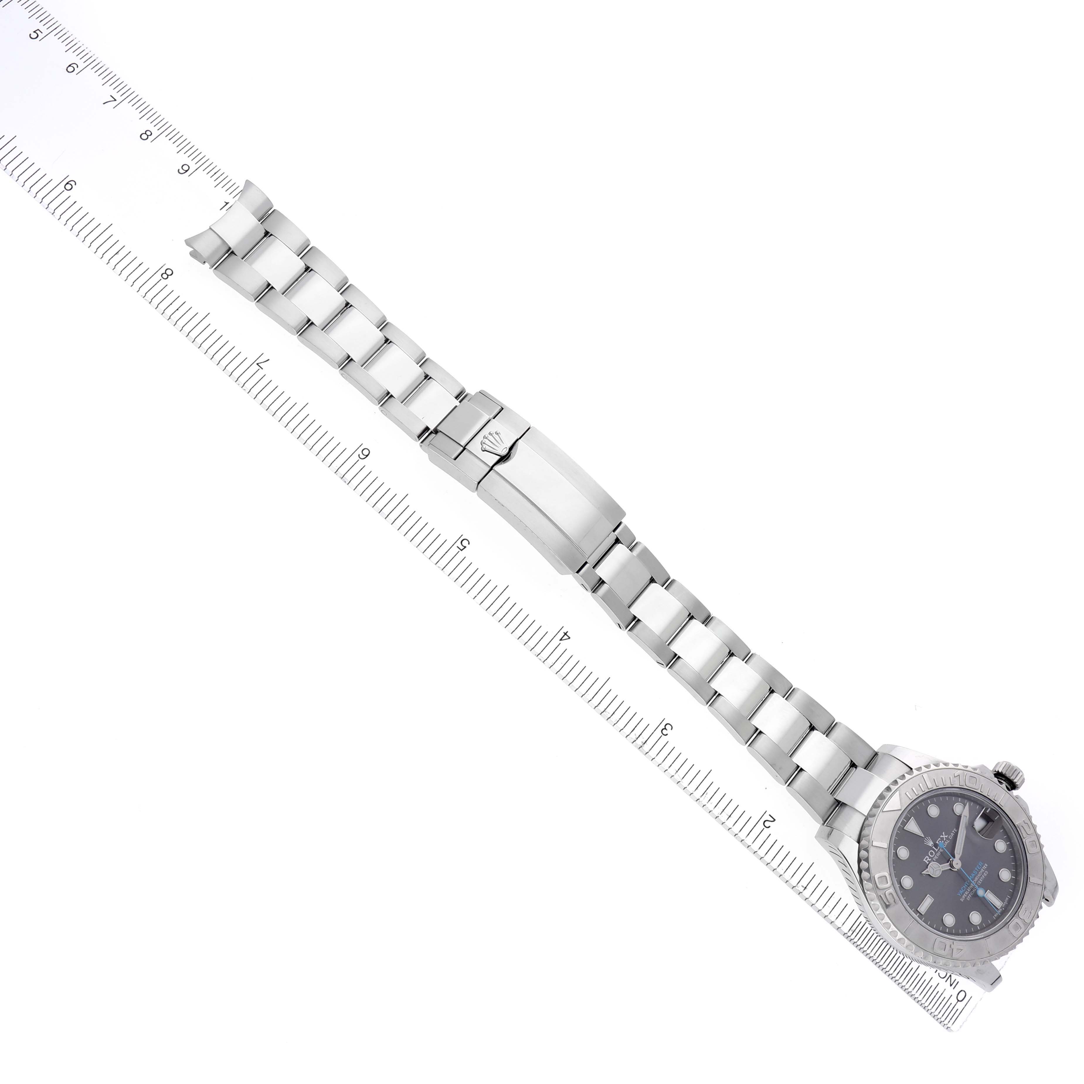 The Rolex Yacht-Master 268622 Men's Stainless Steel Grey Dial 268622 Men's Stainless Steel Grey Dial watch is shown from an overhead angle, displaying the face and full bracelet alongside a ruler.