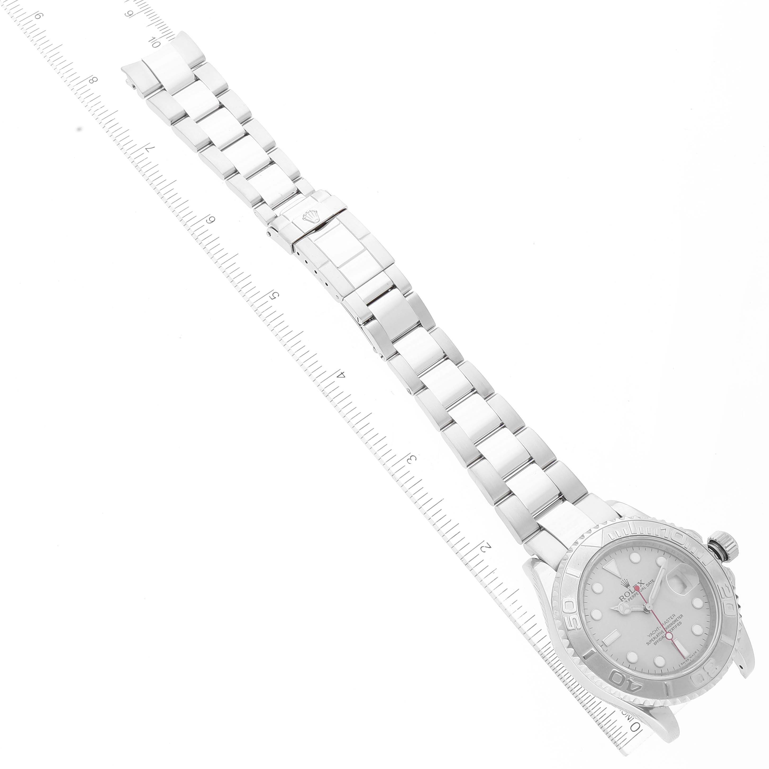 The image shows a Rolex Yacht-Master 16622 Men's Stainless Steel Silver Dial 16622 Men's Stainless Steel Silver Dial watch laid flat with its full length, including the bracelet and clasp, alongside a ruler for scale.