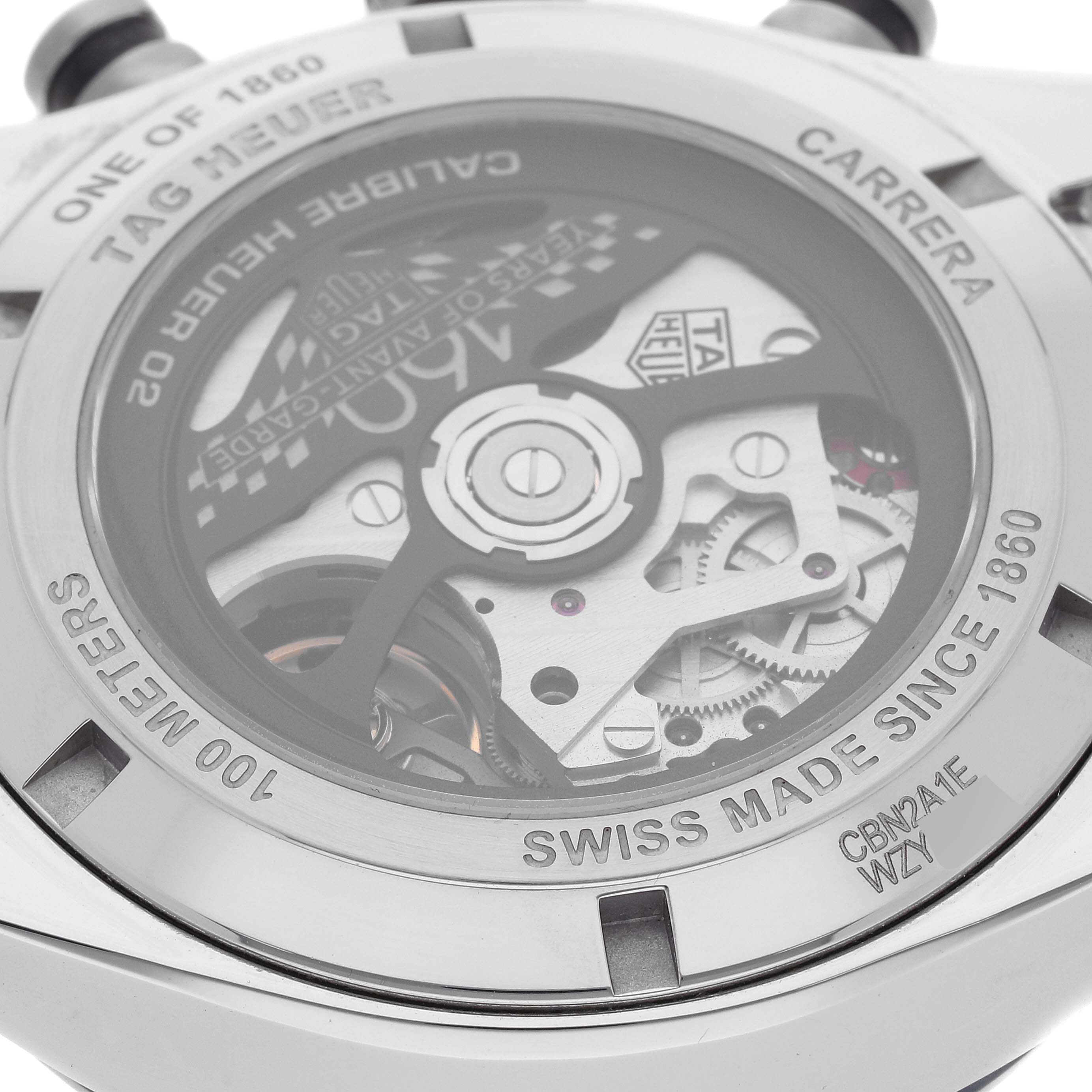 The image shows the back view of a Tag Heuer Carrera CBN2A1E.BA0643 Men's Stainless Steel Blue Dial CBN2A1E.BA0643 Men's Stainless Steel Blue Dial watch, highlighting its inner mechanism and inscriptions.