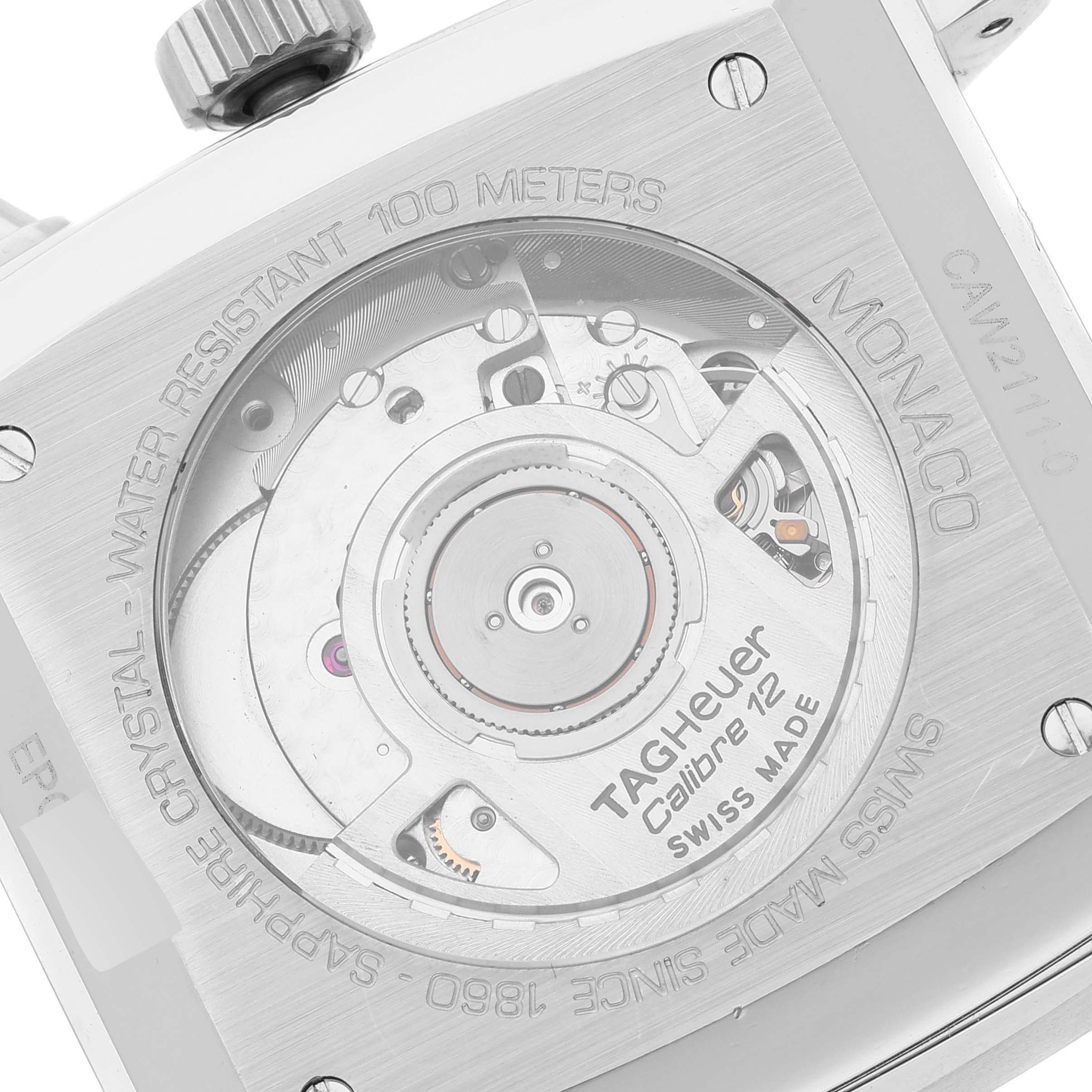 The image shows the back side of a Tag Heuer Monaco CAW2111 Men's Stainless Steel Blue Dial CAW2111 Men's Stainless Steel Blue Dial watch, revealing its Calibre 12 movement and engravings.