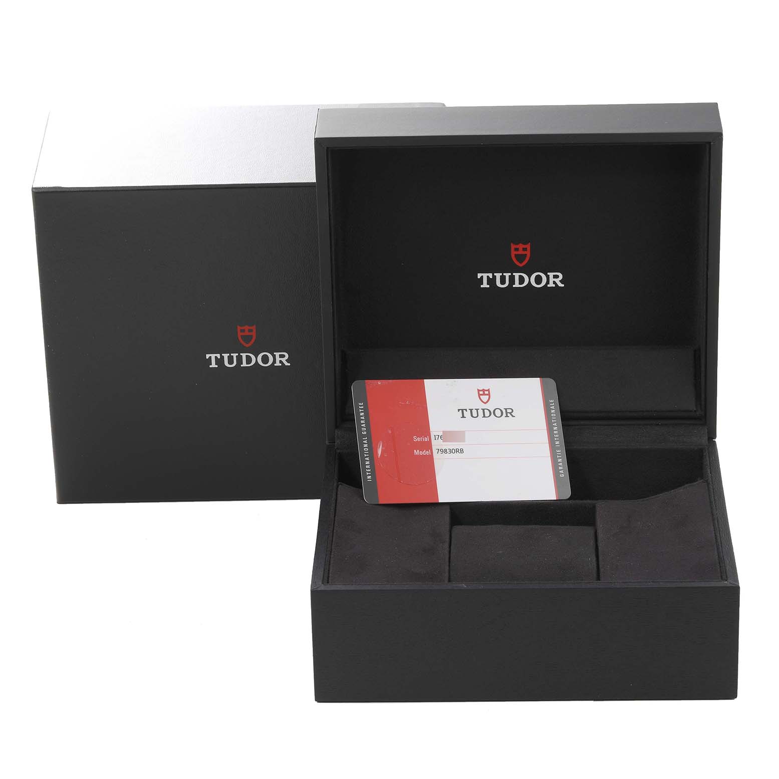The image shows the packaging and warranty card for a Tudor Heritage Black Bay 79830RB Men
s Stainless Steel Black Dial 79830RB Men
s Stainless Steel Black Dial watch.