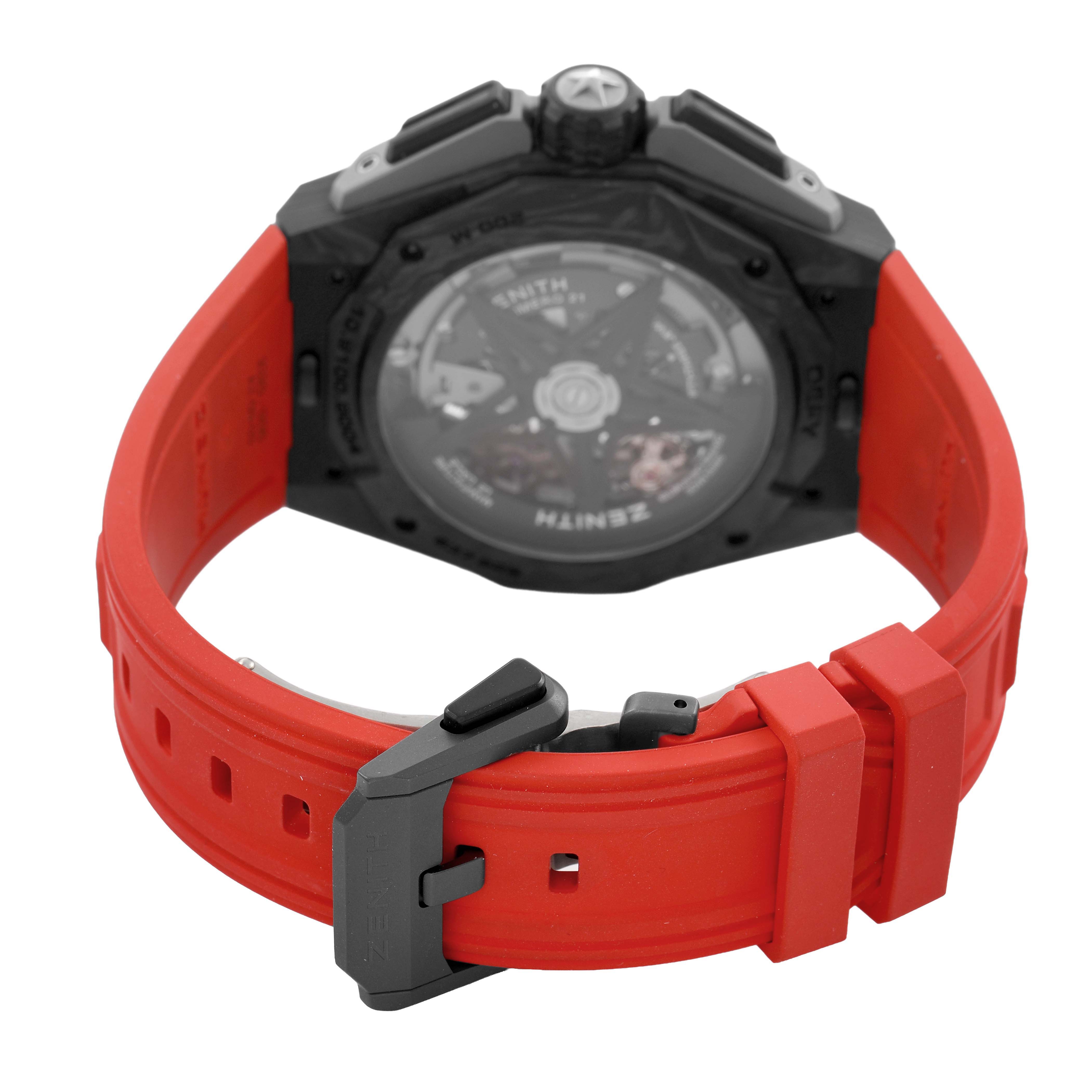 The image shows the back of the Zenith Defy 10.9100.9004/22.I200 Men's Ceramic Black Dial watch, highlighting the transparent case back and red strap with clasp.