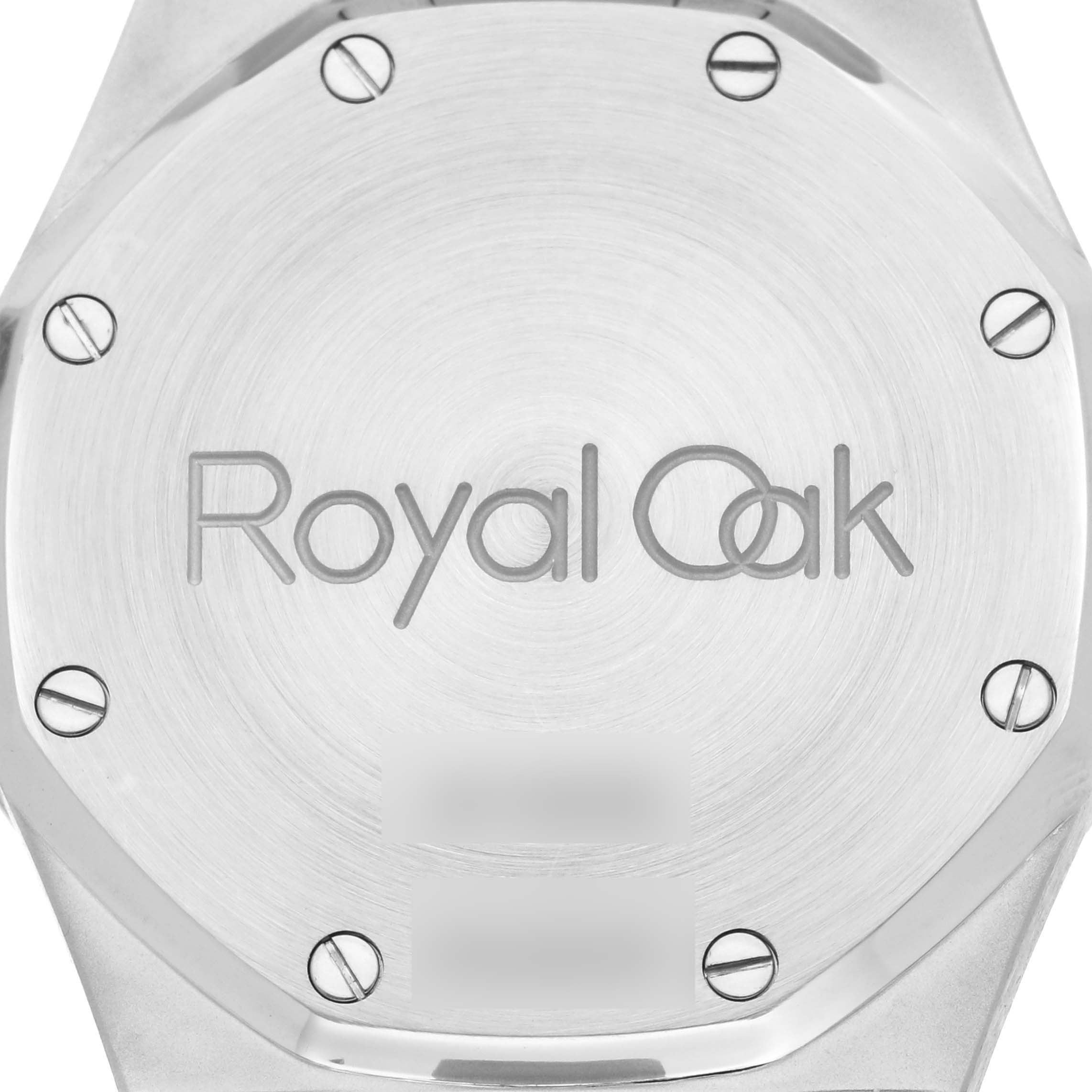 This image shows the back case of a Royal Oak model by Audemars Piguet at a straight-on angle, featuring the engraved logo and screws.