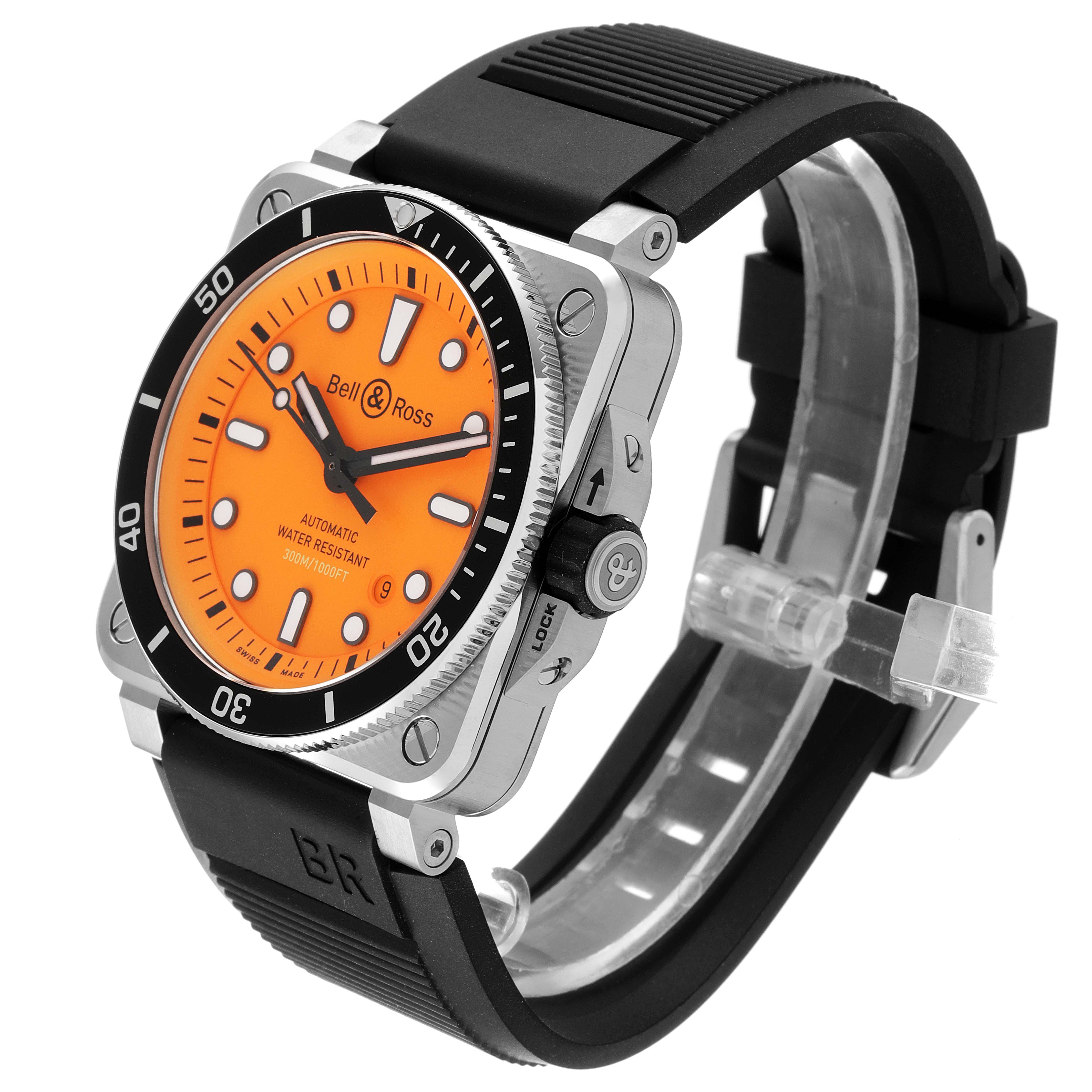 The Bell & Ross Diver watch is shown at a three-quarter angle, highlighting its orange dial, black bezel, and black rubber strap.