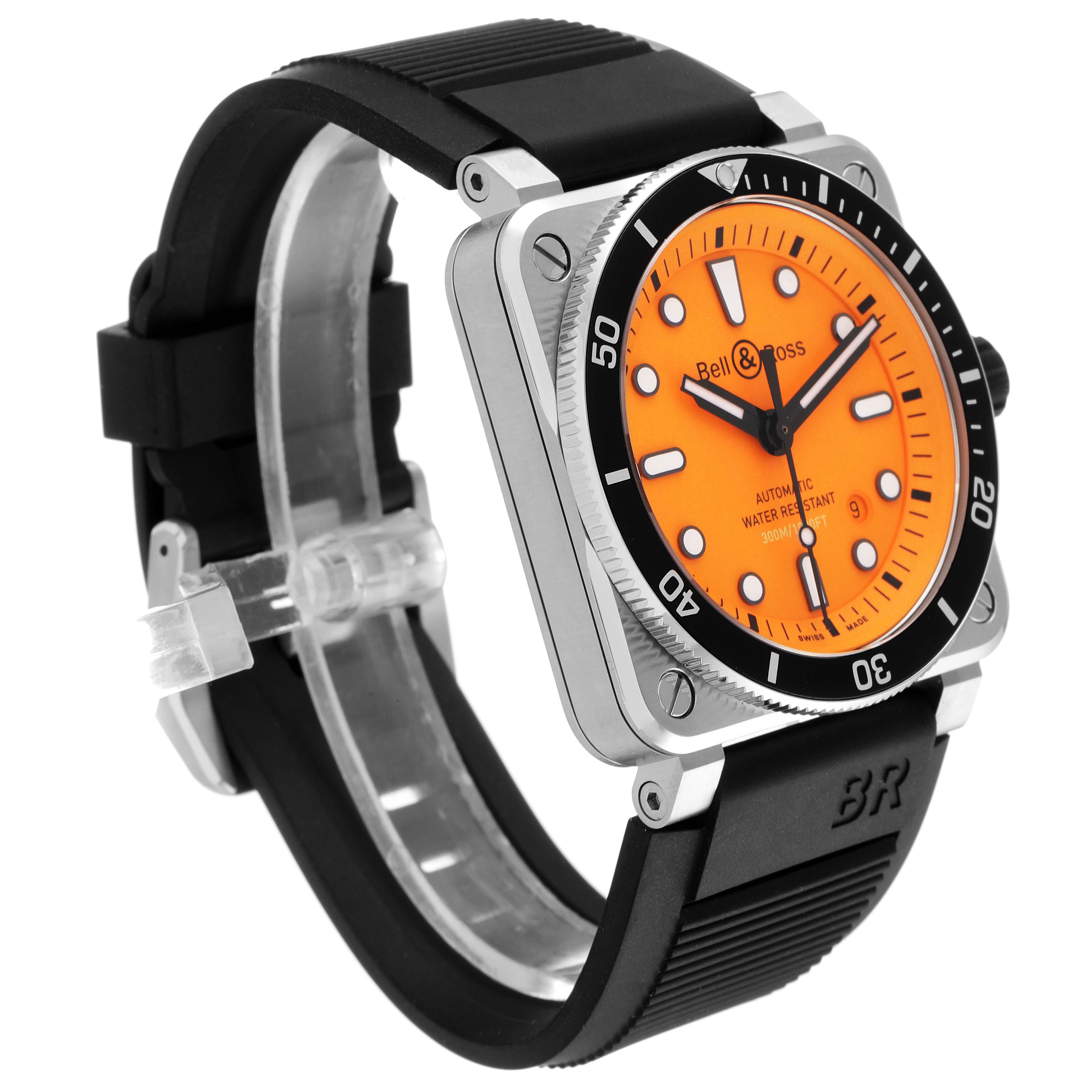 The image shows a Bell & Ross Diver model watch at a three-quarter angle, highlighting the orange dial, black rubber strap, and bezel.