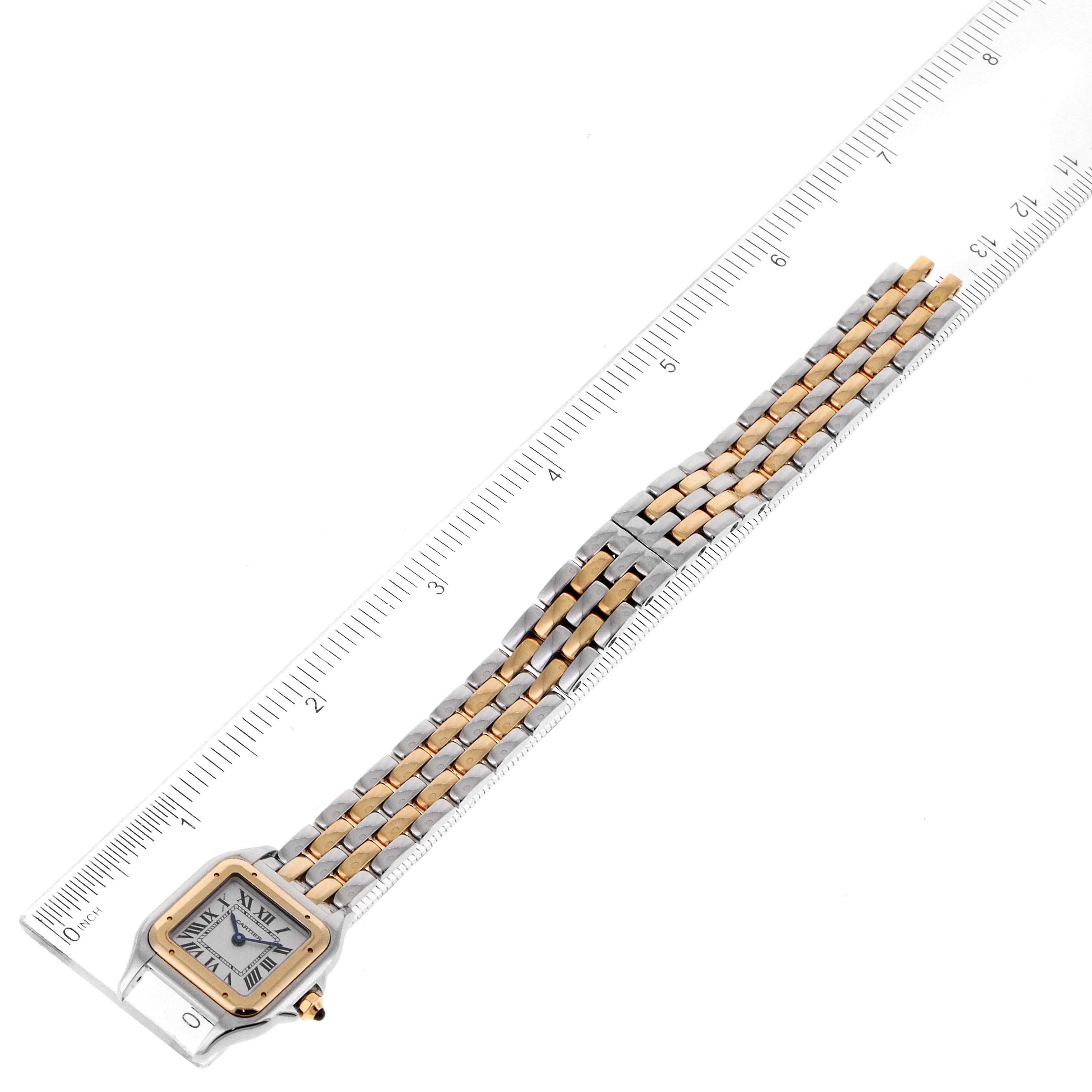 The Cartier Panthere W2PN0006 Women's Steel and Gold (two tone) Silver Dial W2PN0006 Women's Steel and Gold (two tone) Silver Dial watch is shown from a top-down angle, featuring its face, bracelet, and a ruler for scale.