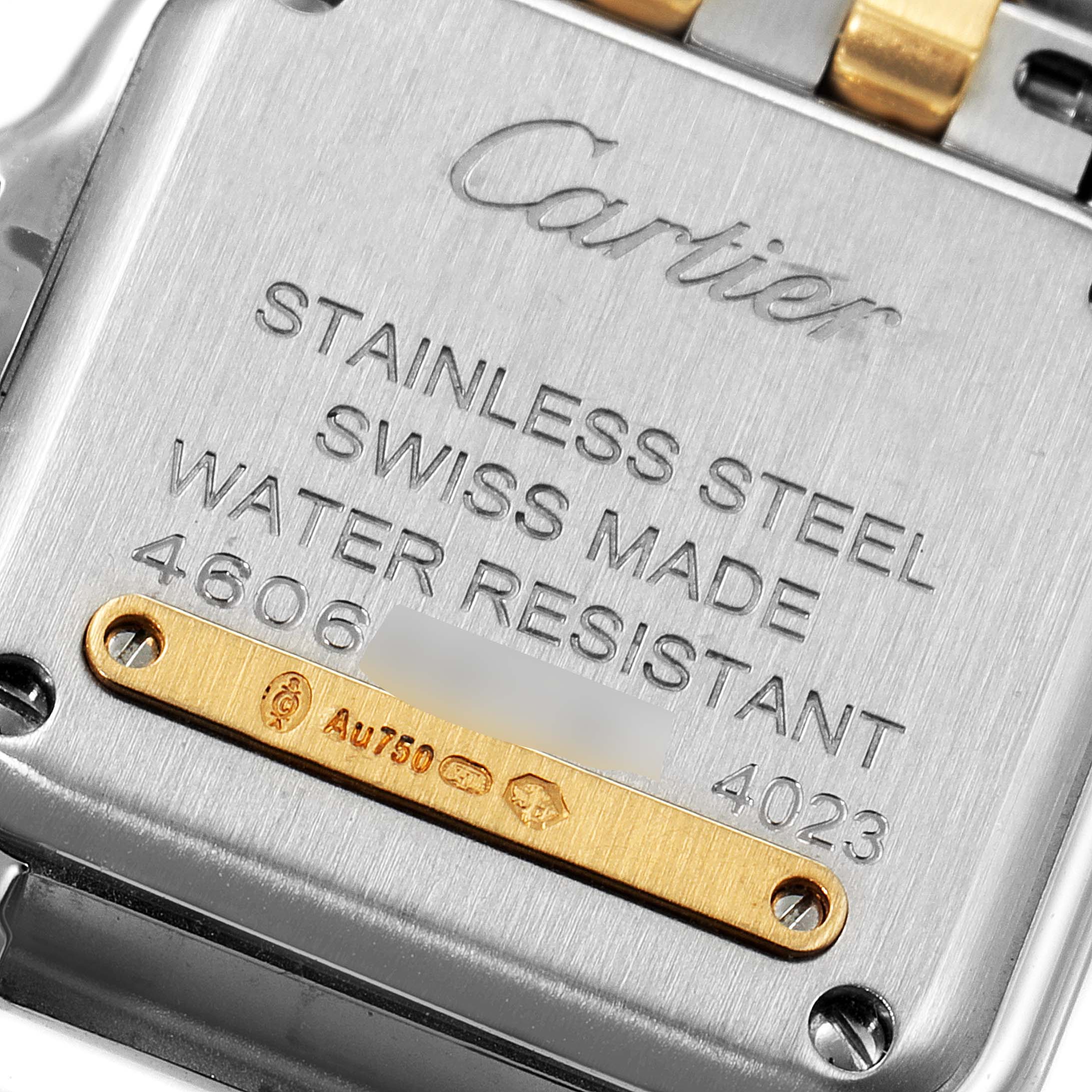 The image shows the case back of a Cartier Panthere W2PN0006 Women's Steel and Gold (two tone) Silver Dial W2PN0006 Women's Steel and Gold (two tone) Silver Dial watch, highlighting its engravings and metal components.
