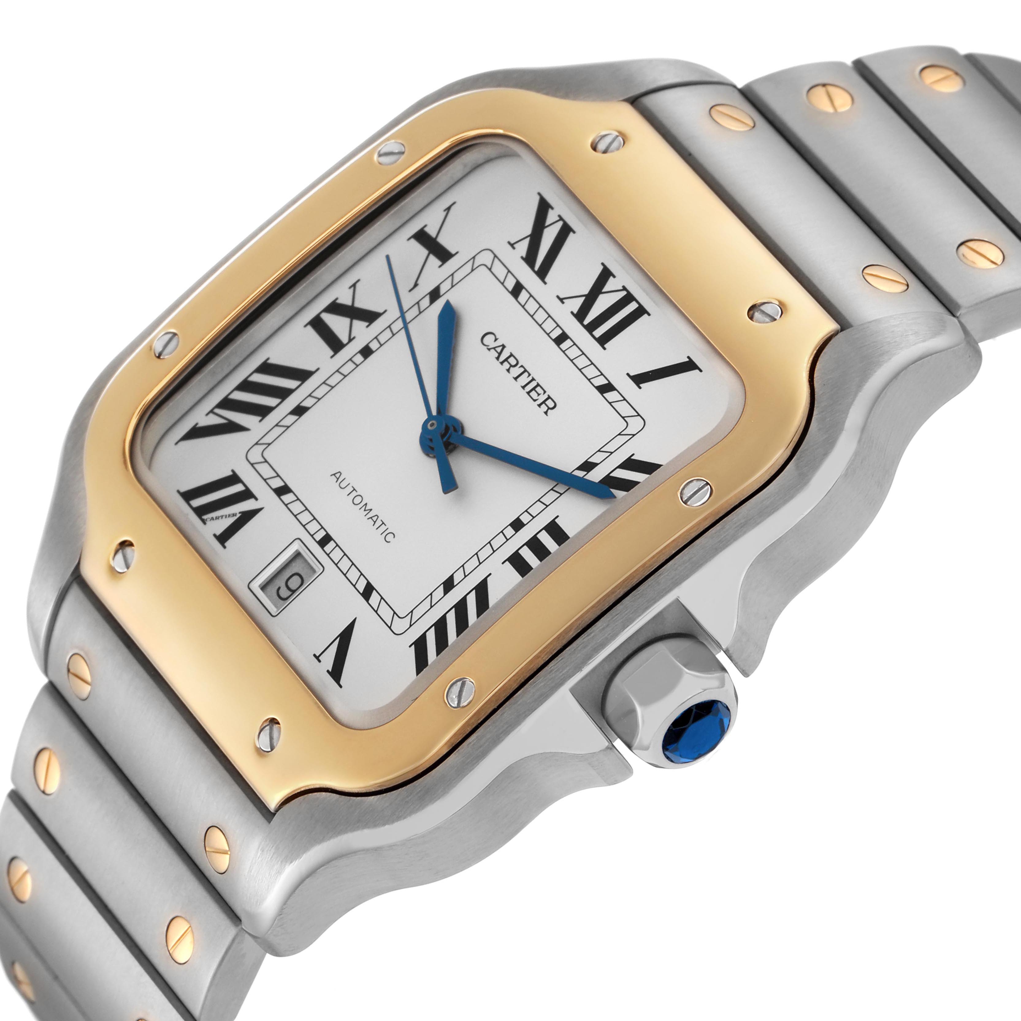 The Cartier Santos W2SA0009 Men's Steel and Gold (two tone) Silver Dial W2SA0009 Men's Steel and Gold (two tone) Silver Dial watch is shown at a slight angle, highlighting its gold bezel, roman numerals, and blue hands.