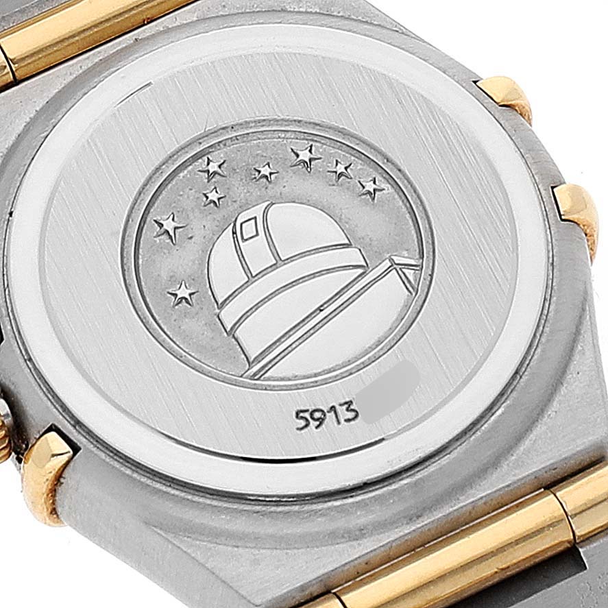 The image shows the back case of the Omega 1267.75.00 Women's Steel and Gold (two tone) Mother of Pearl Dial 1267.75.00 Women's Steel and Gold (two tone) Mother of Pearl Dial Constellation 95 Mother of Pearl Diamond Ladies Watch 1267.75.00 with the observatory logo and partial bracelet.