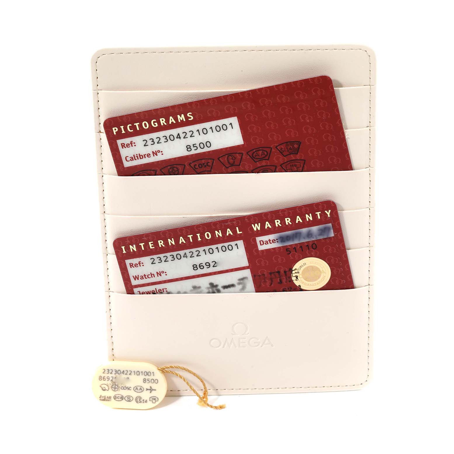 The image shows a holder containing pictogram and international warranty cards for the Omega Planet Ocean 232.30.42.21.01.003 Men
s Stainless Steel Black Dial 232.30.42.21.01.003 Men
s Stainless Steel Black Dial watch along with a hang tag.