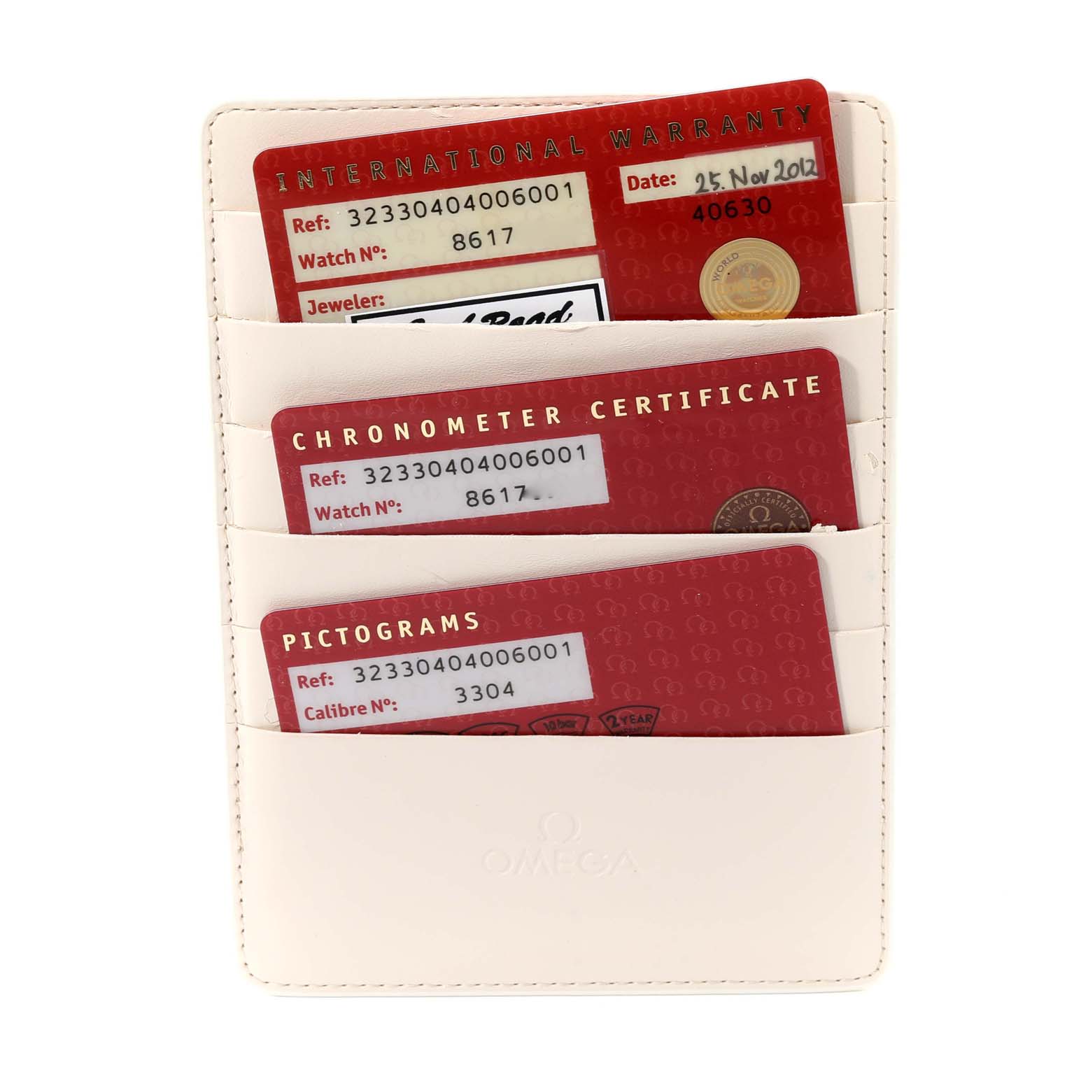 The image shows warranty and certification cards for the Omega Speedmaster 323.30.40.40.06.001 Men's Stainless Steel Grey Dial 323.30.40.40.06.001 Men's Stainless Steel Grey Dial, neatly organized in a white cardholder.