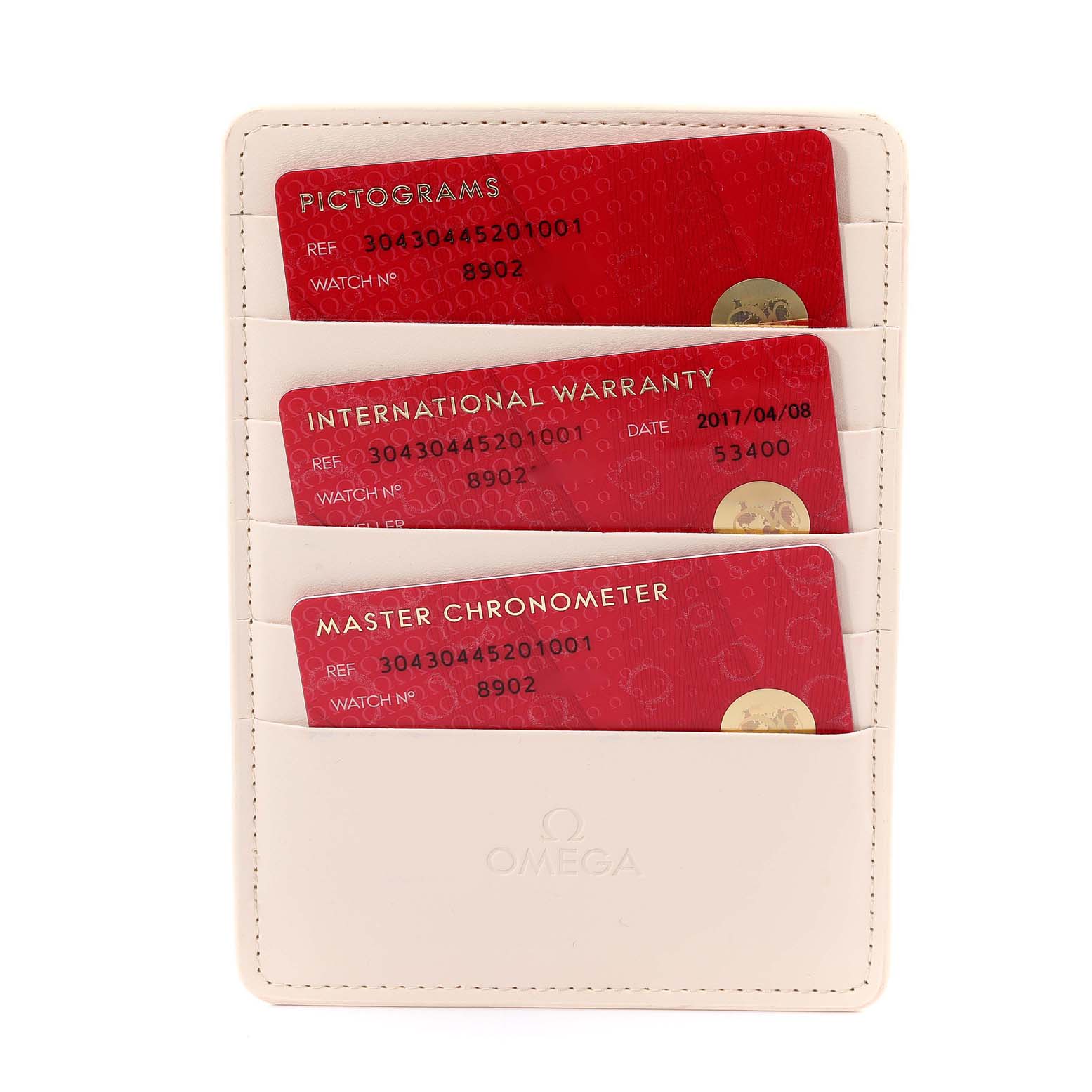 The image shows three Omega Speedmaster 304.30.44.52.01.001 Men's Stainless Steel Black Dial 304.30.44.52.01.001 Men's Stainless Steel Black Dial cards (Pictograms, International Warranty, and Master Chronometer) in a white cardholder from a top-down angle.