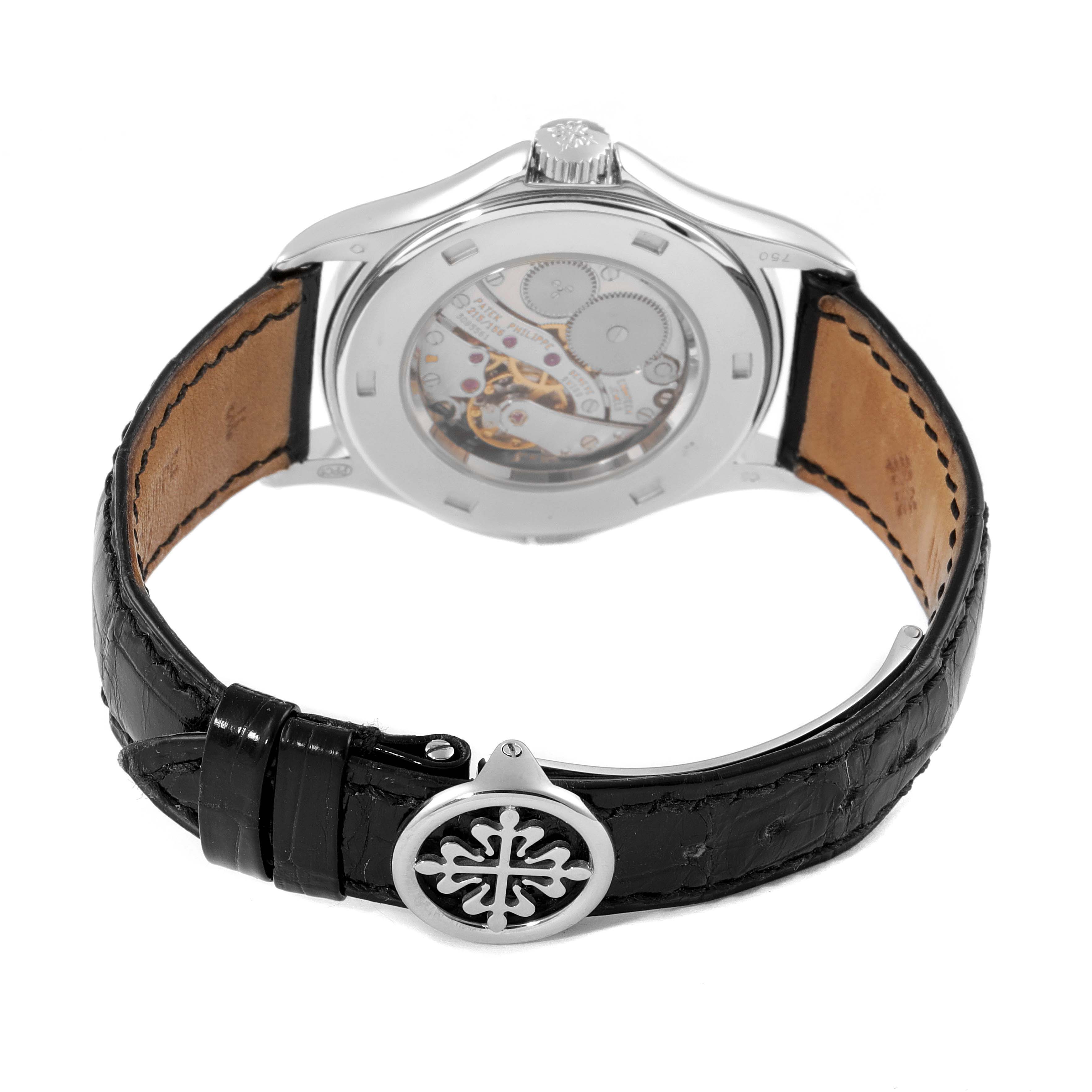 The image shows the back of the Patek Philippe Calatrava 5134G Men
s White Gold White Dial 5134G Men
s White Gold White Dial watch, displaying its transparent case back and leather strap with the clasp.