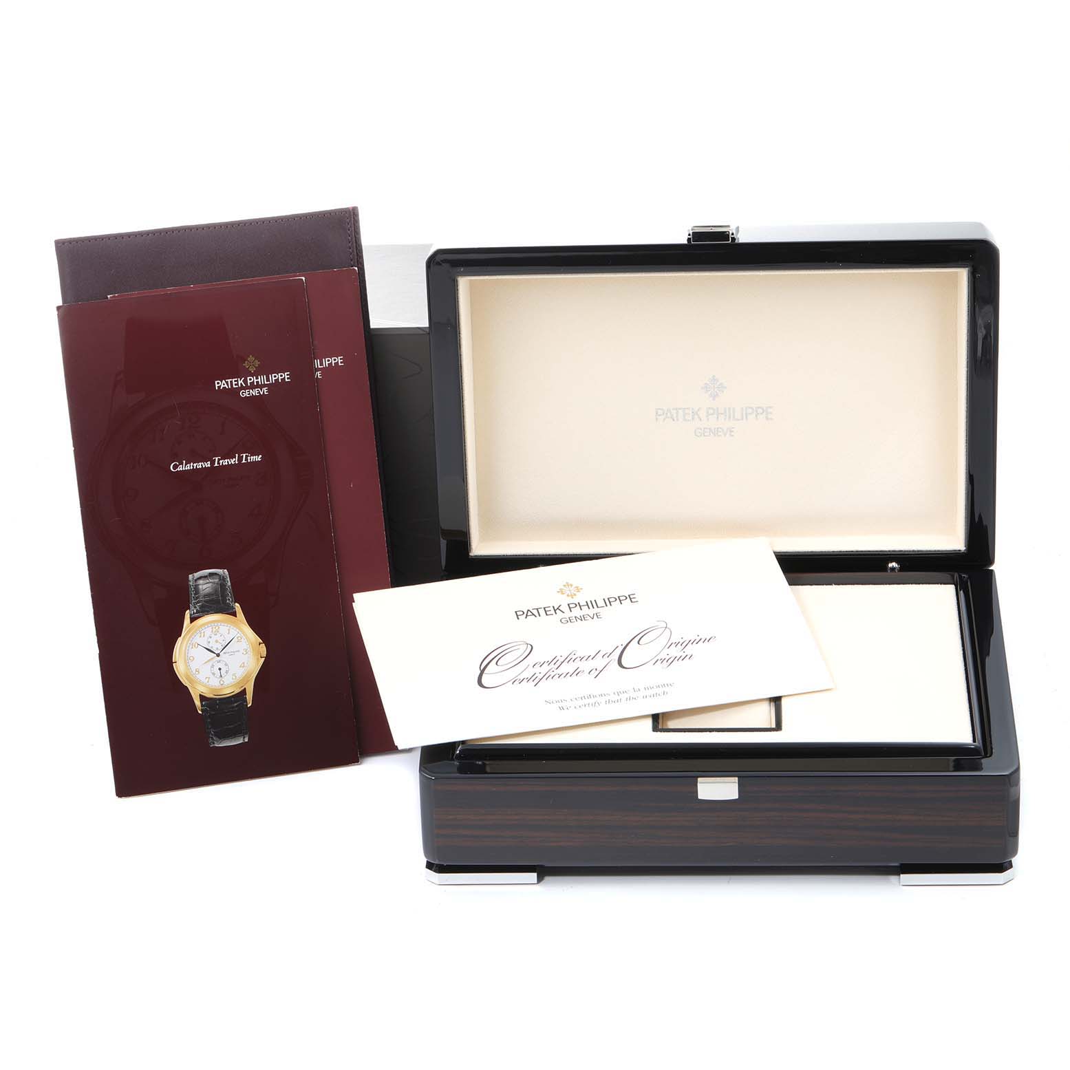 The image shows the packaging, manual, and certificate of a Patek Philippe Calatrava 5134G Men
s White Gold White Dial 5134G Men
s White Gold White Dial watch, with an open box and accompanying booklets.