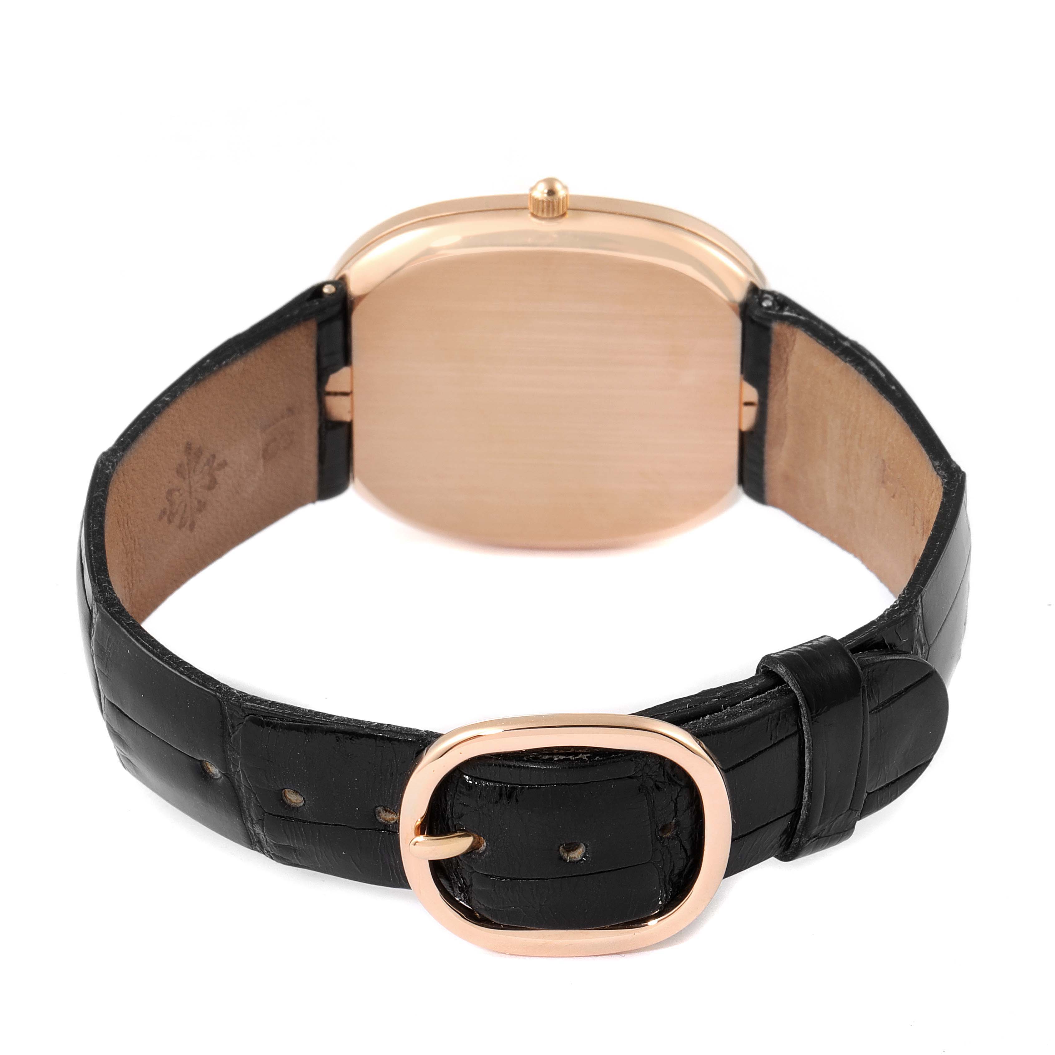 The image shows the back of the Patek Philippe Golden Ellipse 3738 Men's Rose Gold Brown Dial 3738 Men's Rose Gold Brown Dial watch and its leather strap with a gold buckle.