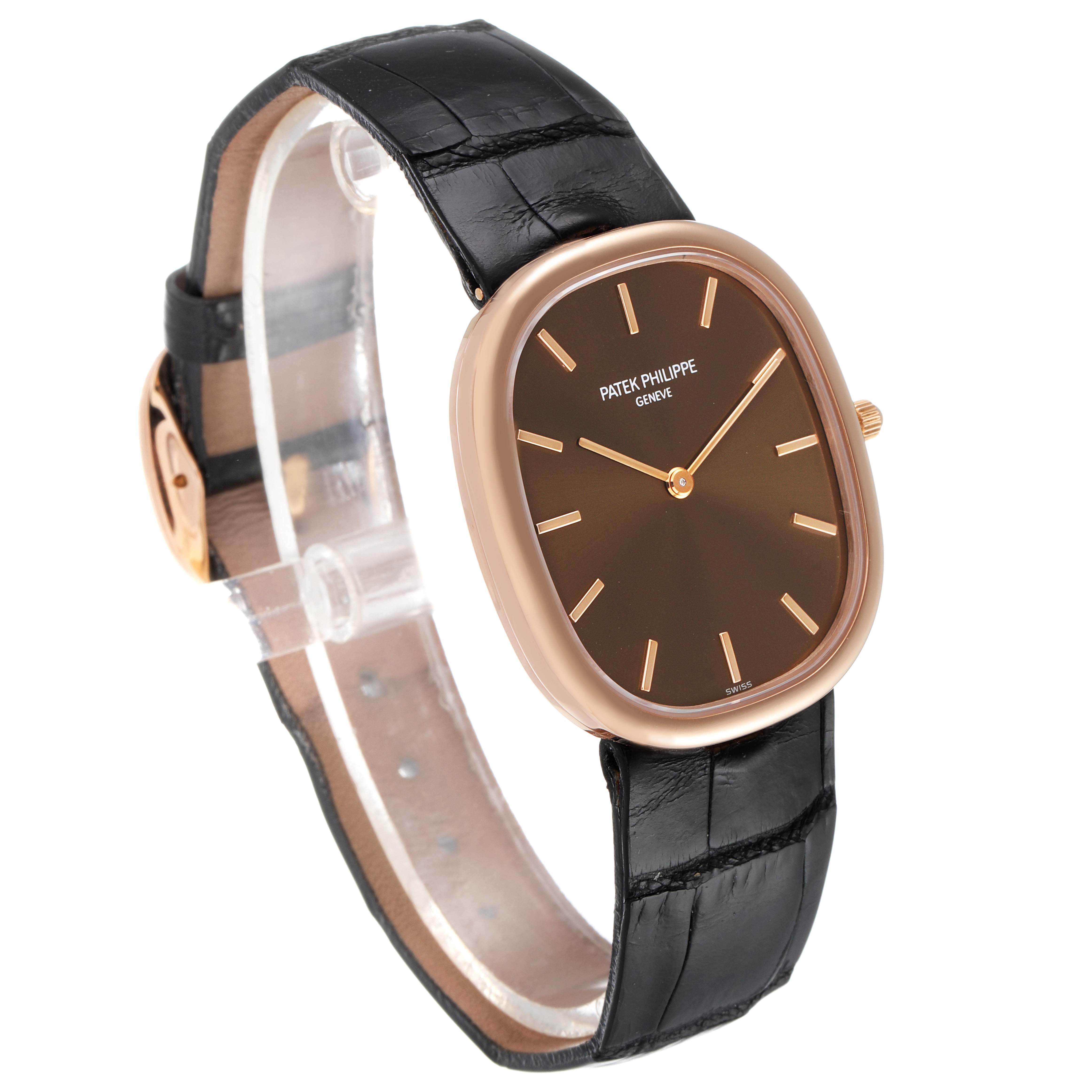 The image showcases a side angle view of the Patek Philippe Golden Ellipse 3738 Men's Rose Gold Brown Dial 3738 Men's Rose Gold Brown Dial watch with a leather strap and oval dial.