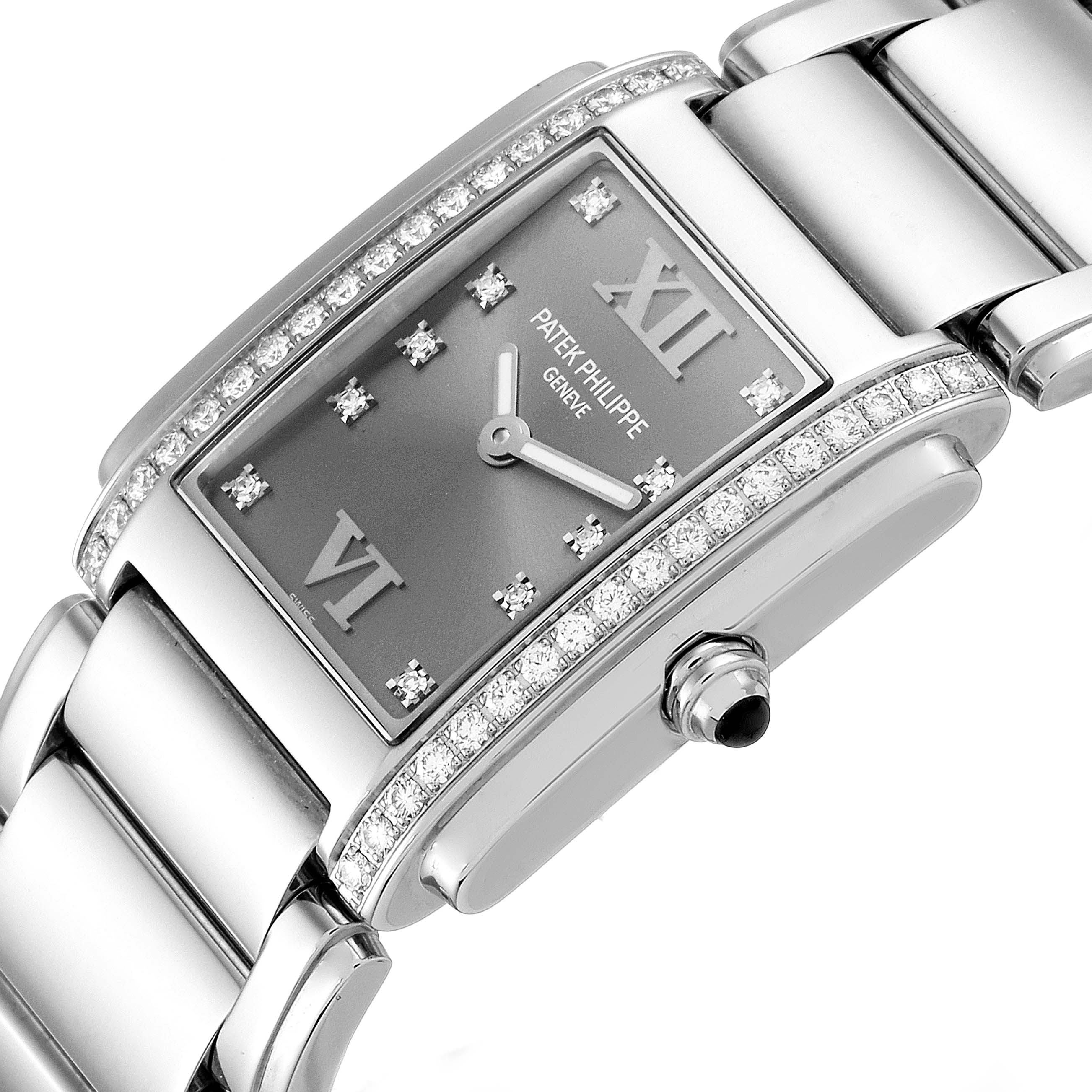 The Patek Philippe Twenty-4 4910/10A-010 Women's Stainless Steel Grey Dial 4910/10A-010 Women's Stainless Steel Grey Dial watch is shown at a three-quarter angle, highlighting its diamond-set bezel, dial, and bracelet.