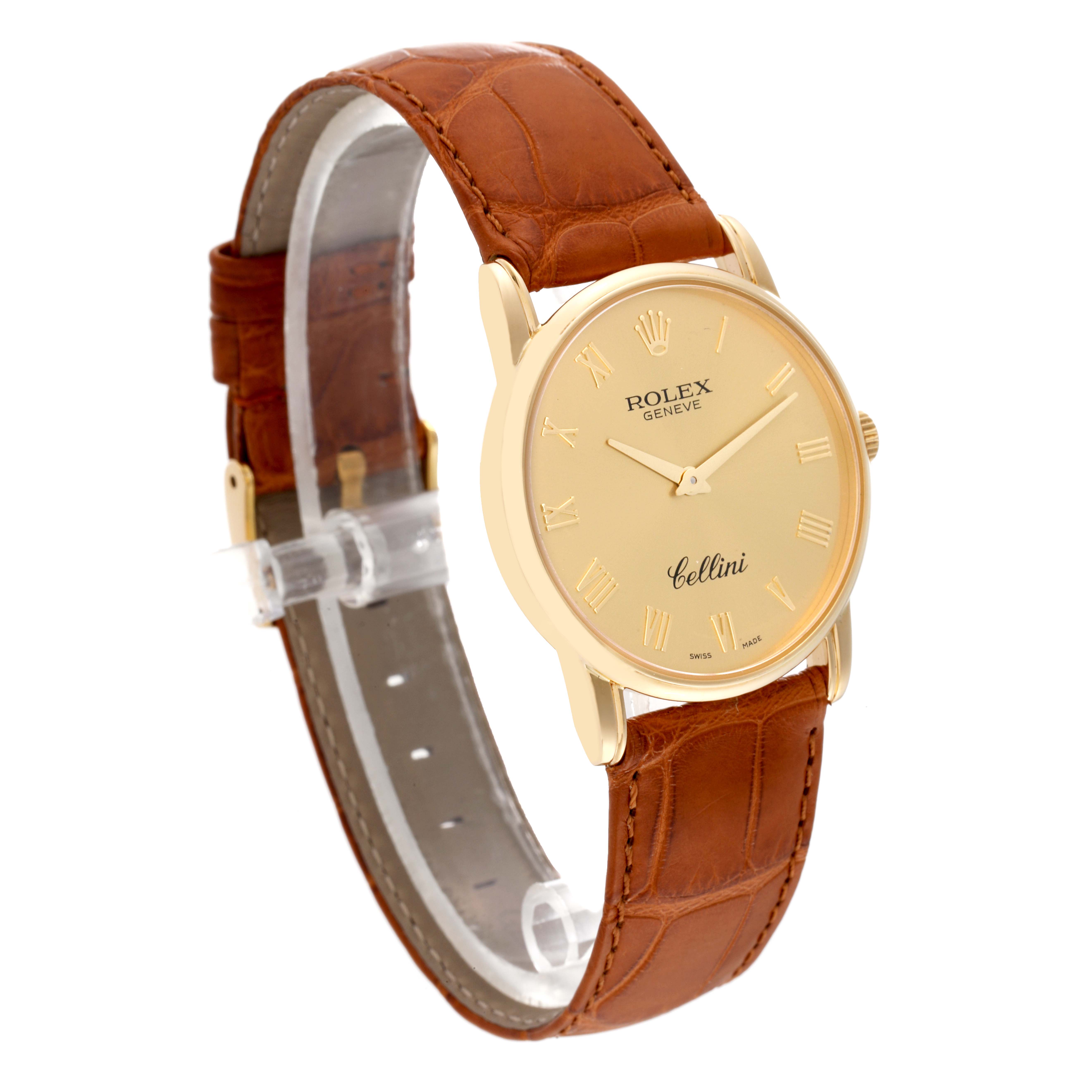 The Rolex Cellini 5116 Men's Yellow Gold Champagne Dial 5116 Men's Yellow Gold Champagne Dial watch is shown at a slight angle, displaying its gold dial, brown leather strap, and gold Roman numeral markers.