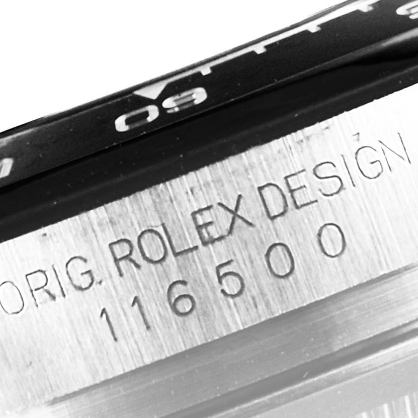 This close-up image shows the engraved serial number and part of the bezel on a Rolex Daytona 116500 Men's Stainless Steel Black Dial 116500 Men's Stainless Steel Black Dial watch.