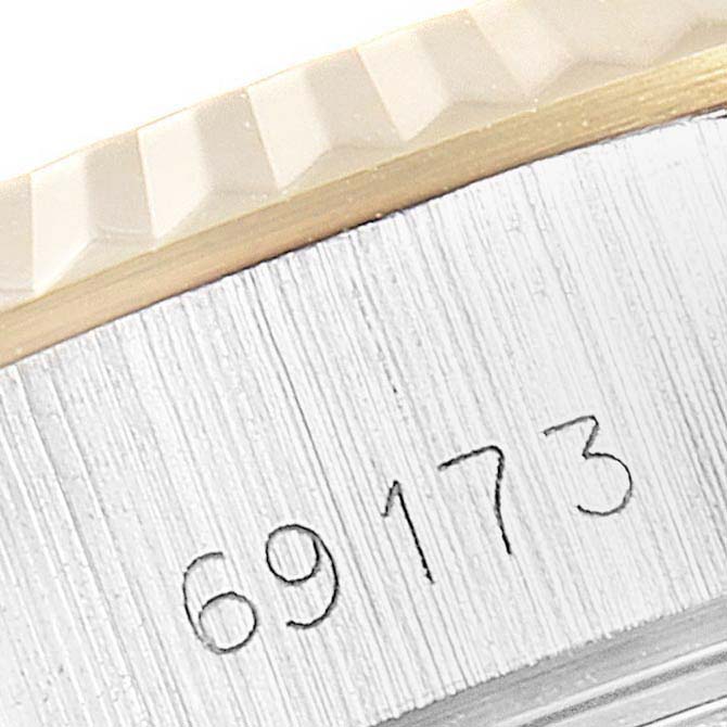 This image shows the case side and part of the fluted bezel with the model number 69173 of a Rolex Datejust 69173 Women
s Steel and Gold (two tone) Champagne Dial 69173 Women
s Steel and Gold (two tone) Champagne Dial watch.