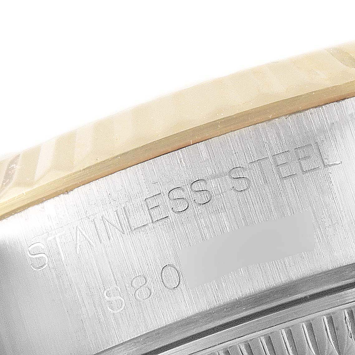 The image shows a close-up of the stainless steel casing on a Rolex Datejust 69173 Women
s Steel and Gold (two tone) Champagne Dial 69173 Women
s Steel and Gold (two tone) Champagne Dial model watch.