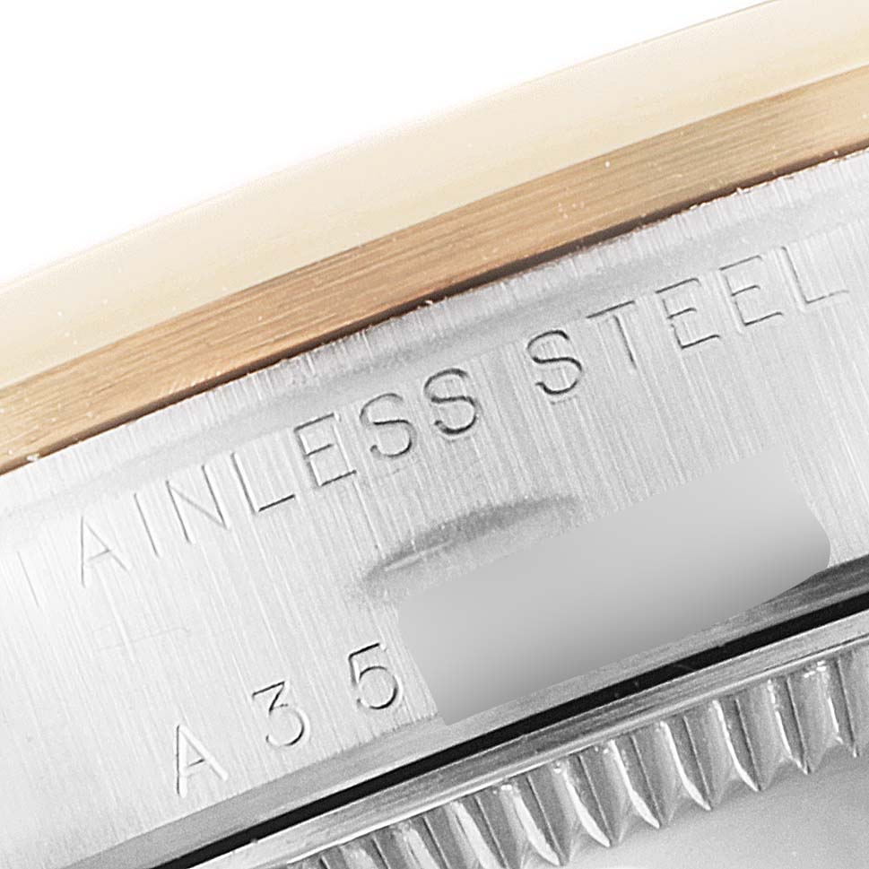 The image shows a close-up view of the side of a Mid-Size Rolex watch, highlighting the stainless steel case and part of the bezel.