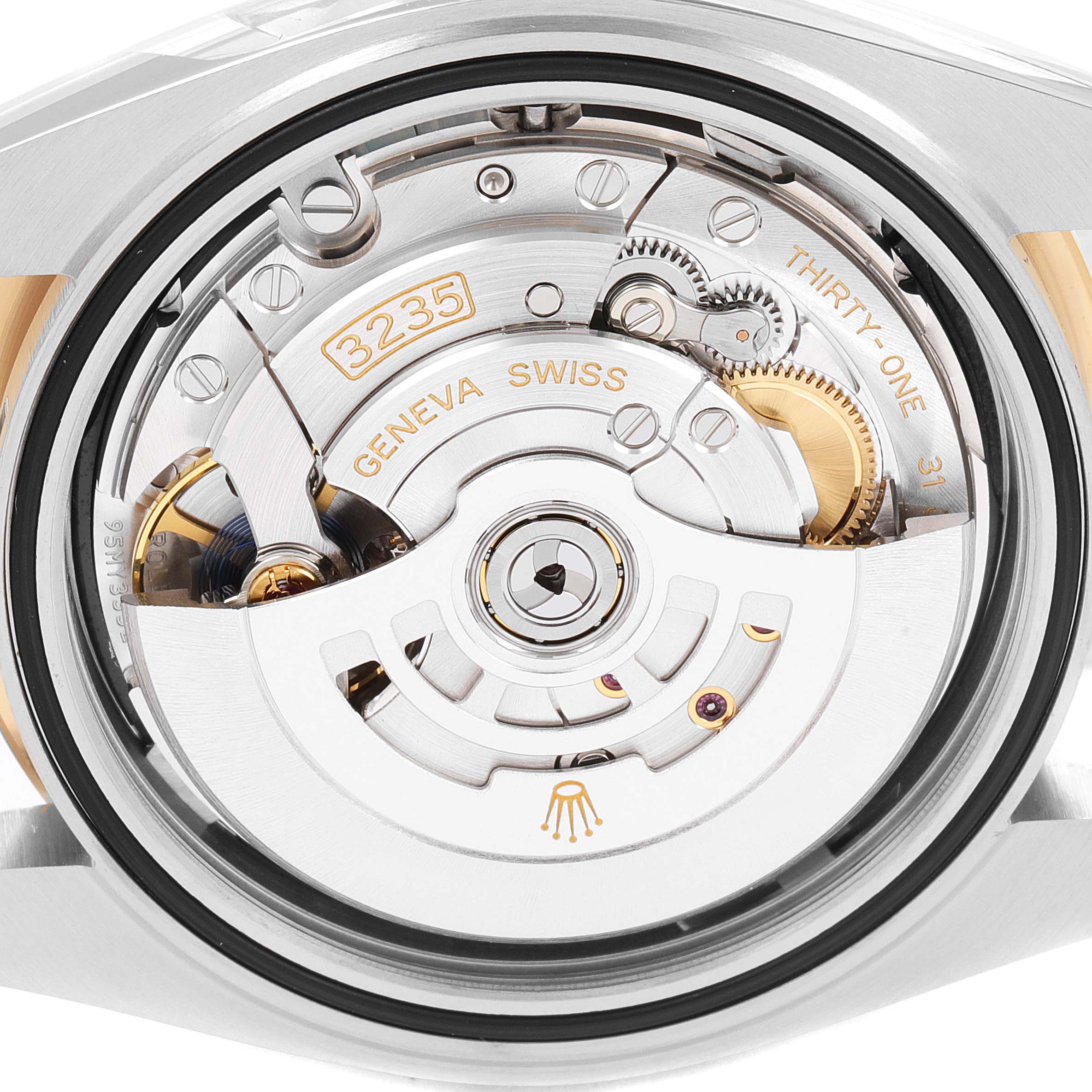 This image shows a close-up view of the movement and internal mechanism of a Rolex Datejust 41 126303 Men's Steel and Gold (two tone) Black Dial 126303 Men's Steel and Gold (two tone) Black Dial watch.