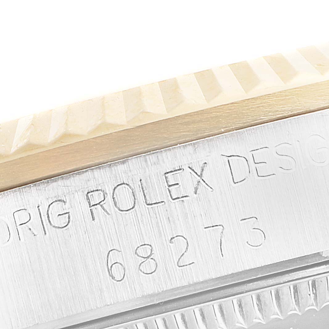 This close-up image of the Mid-Size Rolex watch shows a portion of the bezel and the engraved case with model number 68273.
