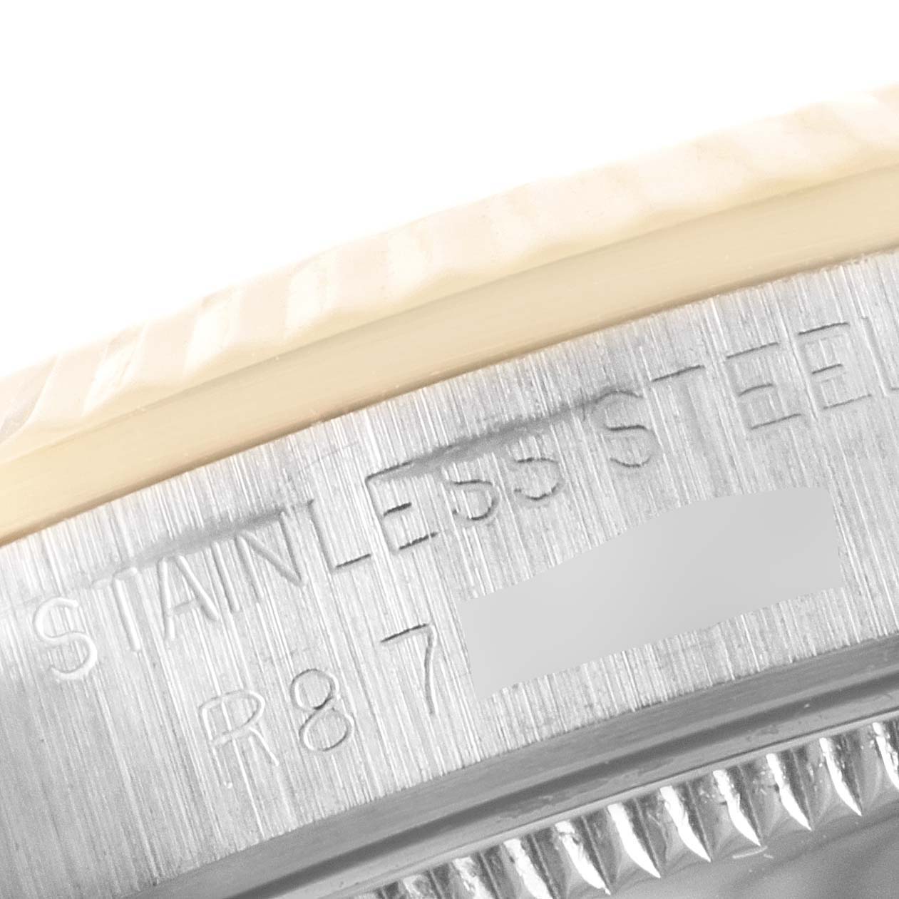 This is a close-up shot of the bezel and part of the stainless steel case of a Rolex Mid-Size 68273 Women's Steel and Gold (two tone) Champagne Dial 68273 Women's Steel and Gold (two tone) Champagne Dial watch.