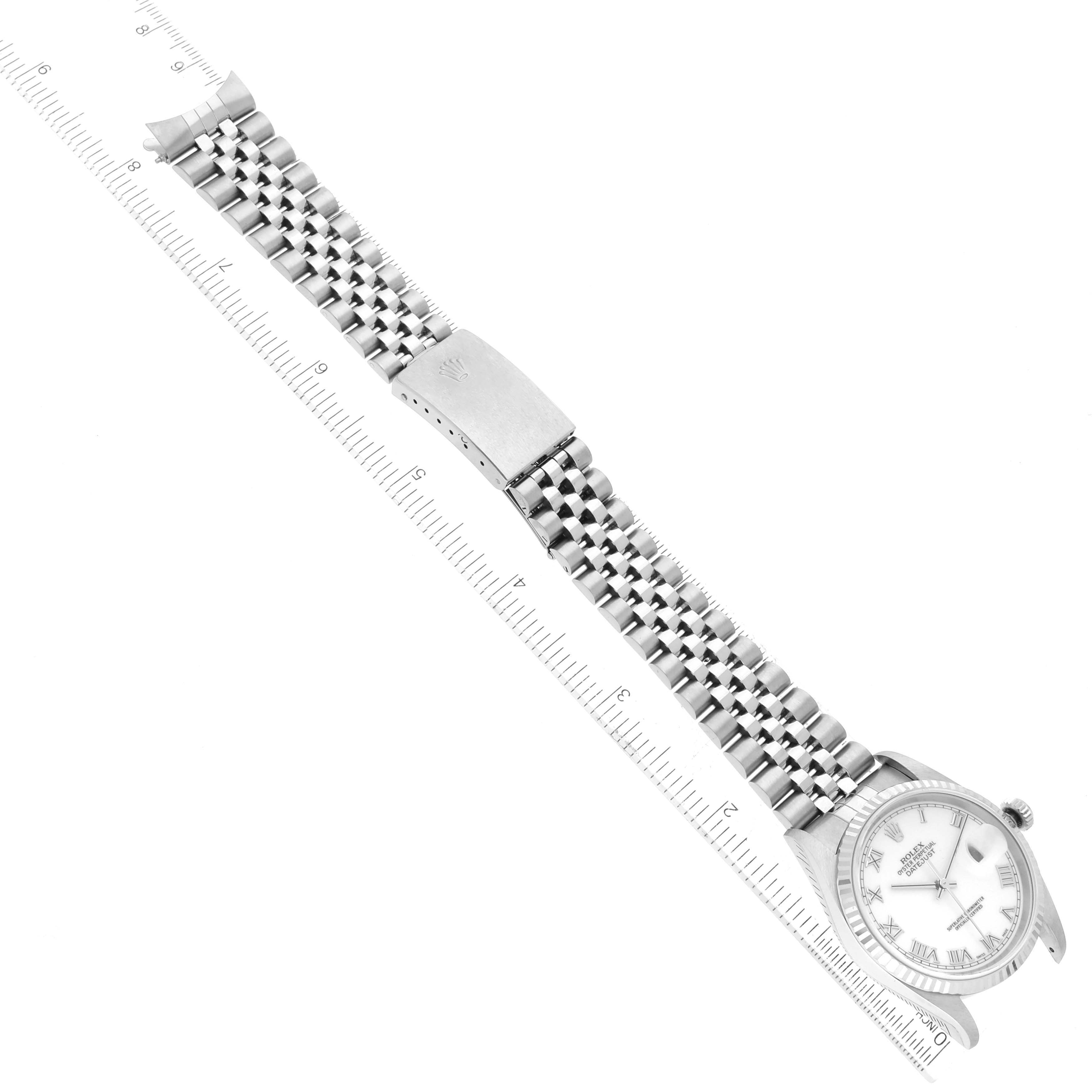 This image shows a Rolex Datejust 16234 Men
s Stainless Steel White Dial 16234 Men
s Stainless Steel White Dial watch laid flat with its bracelet and clasp visible, alongside a measuring ruler.