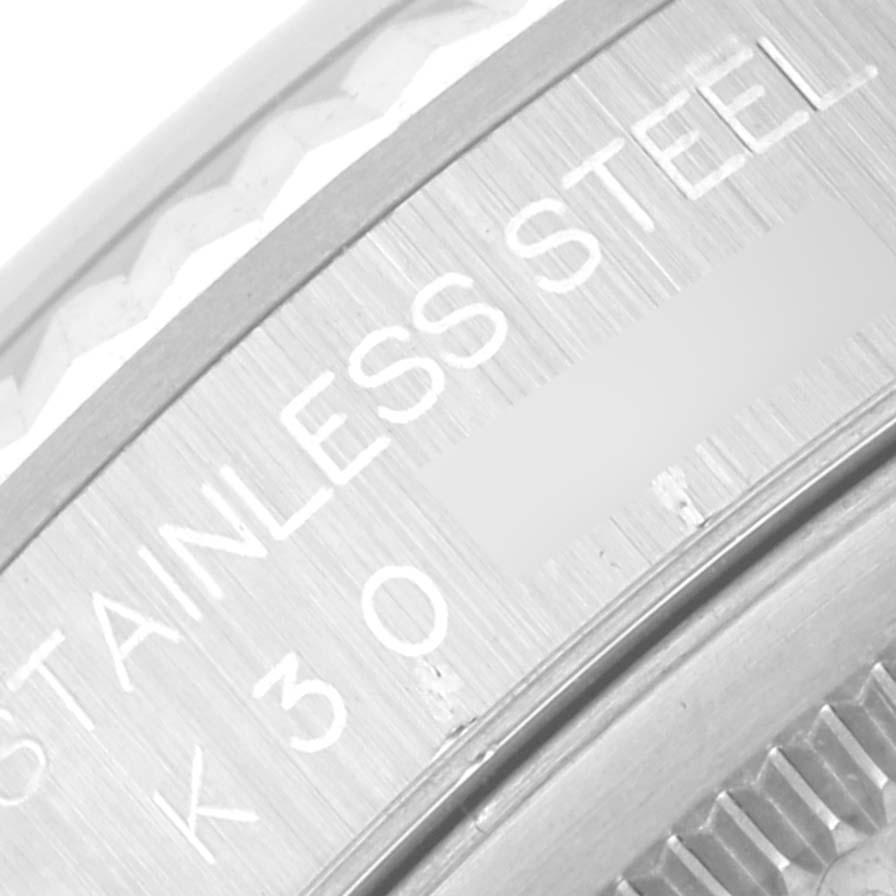 The image shows a close-up of the stainless steel bezel and part of the case back of a Rolex Datejust 16234 Men
s Stainless Steel White Dial 16234 Men
s Stainless Steel White Dial watch.