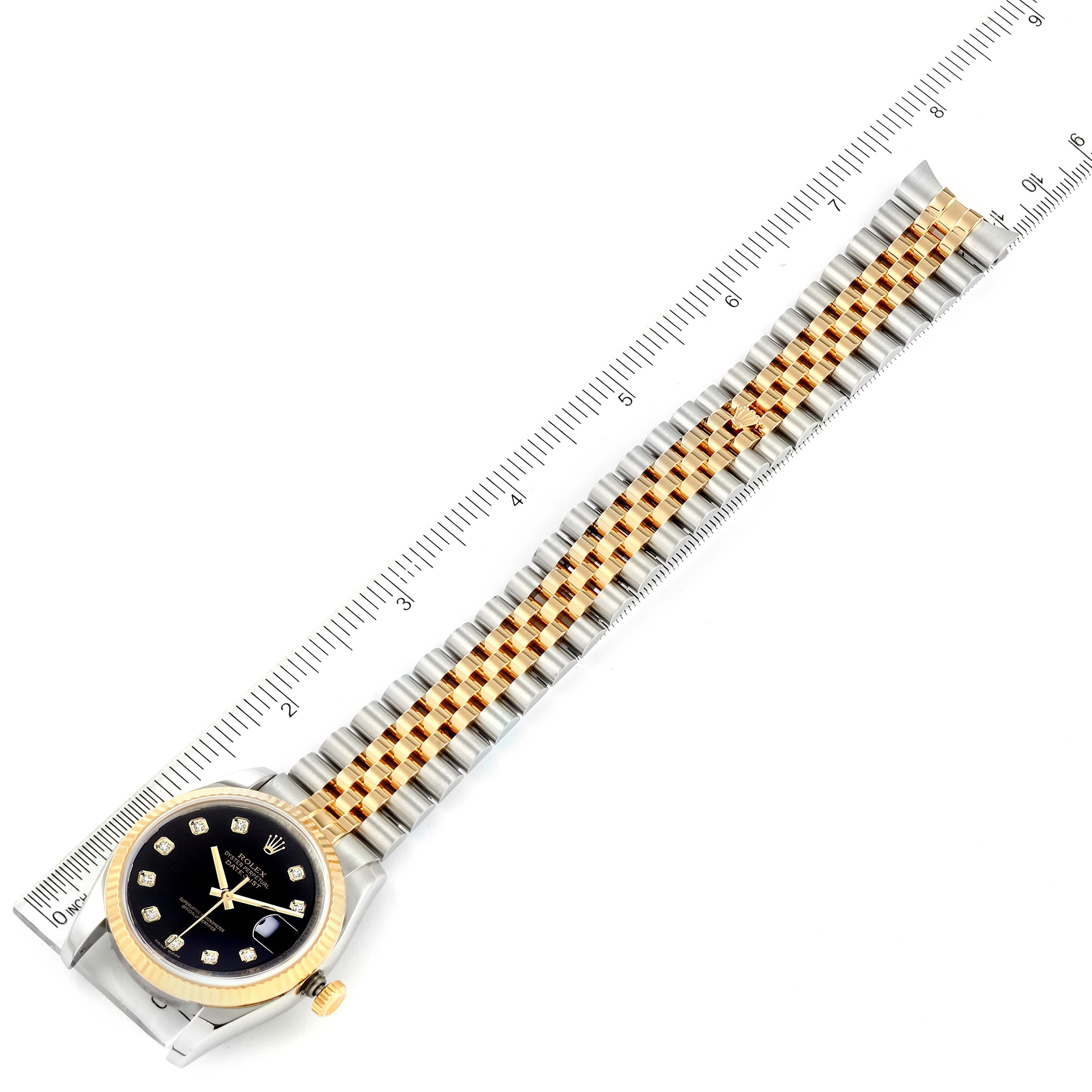 The image shows a Rolex Datejust 116233 Men's Steel and Gold (two tone) Black Dial 116233 Men's Steel and Gold (two tone) Black Dial watch laid flat with its metal strap extended, measured by a ruler.