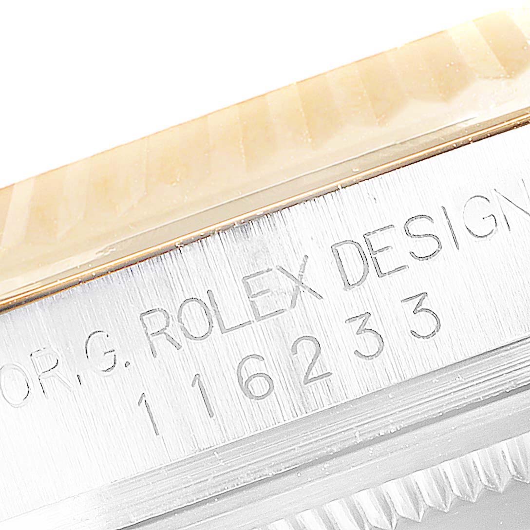 This image shows a close-up of the case and serial number engraving on a Rolex Datejust 116233 Men's Steel and Gold (two tone) Black Dial 116233 Men's Steel and Gold (two tone) Black Dial watch.