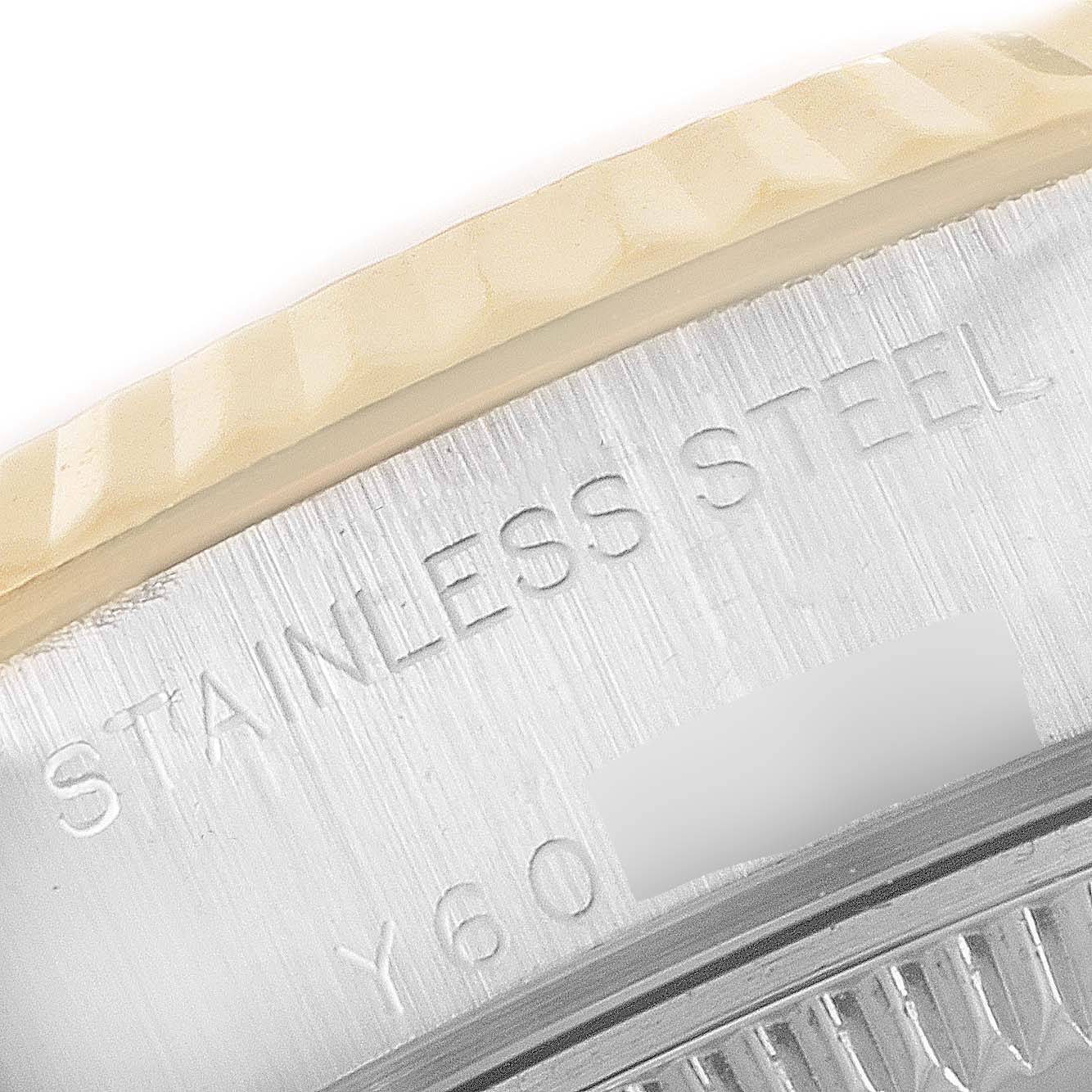 This close-up image of the Rolex Datejust 79173 Women
s Steel and Gold (two tone) Black Dial 79173 Women
s Steel and Gold (two tone) Black Dial shows part of the bezel and the "Stainless Steel" engraving.