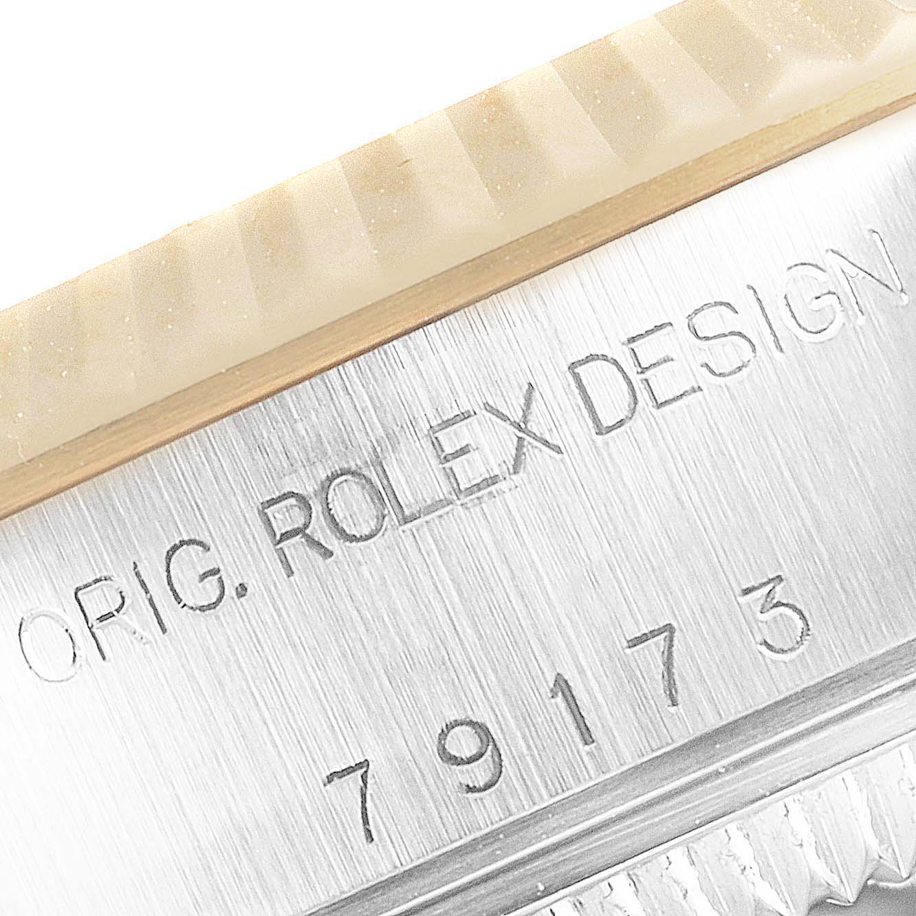 This image shows a close-up angle of the serial number and engraving on the side of the Rolex Datejust 79173 Women
s Steel and Gold (two tone) Black Dial 79173 Women
s Steel and Gold (two tone) Black Dial watch case.