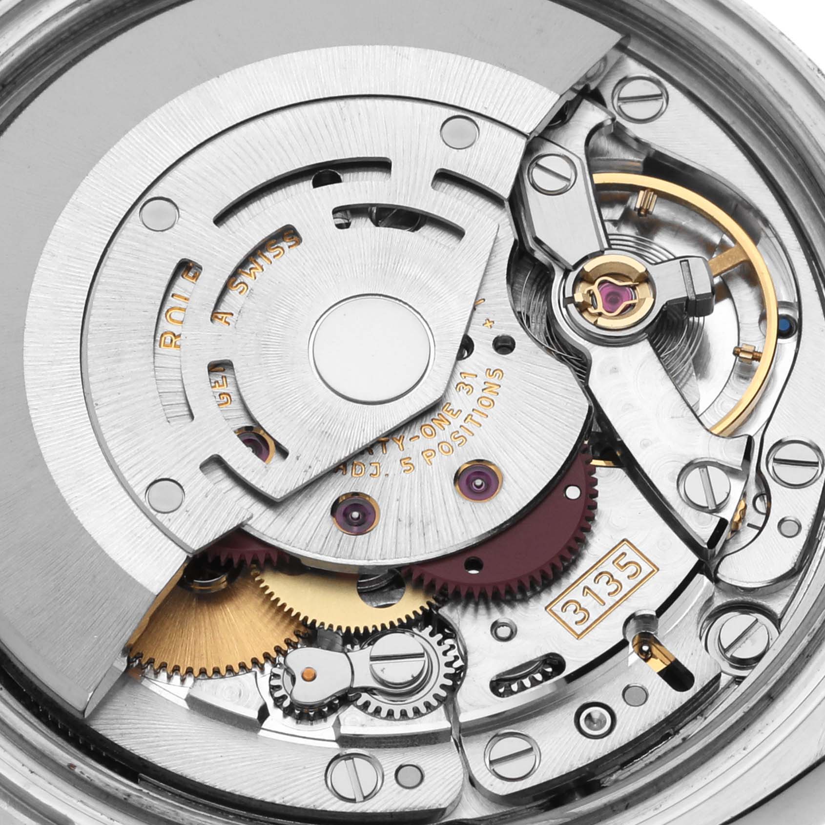 Close-up of the internal mechanism of a Rolex Datejust 116233 Men's Steel and Gold (two tone) Silver Dial 116233 Men's Steel and Gold (two tone) Silver Dial watch, showcasing gears and intricate parts.