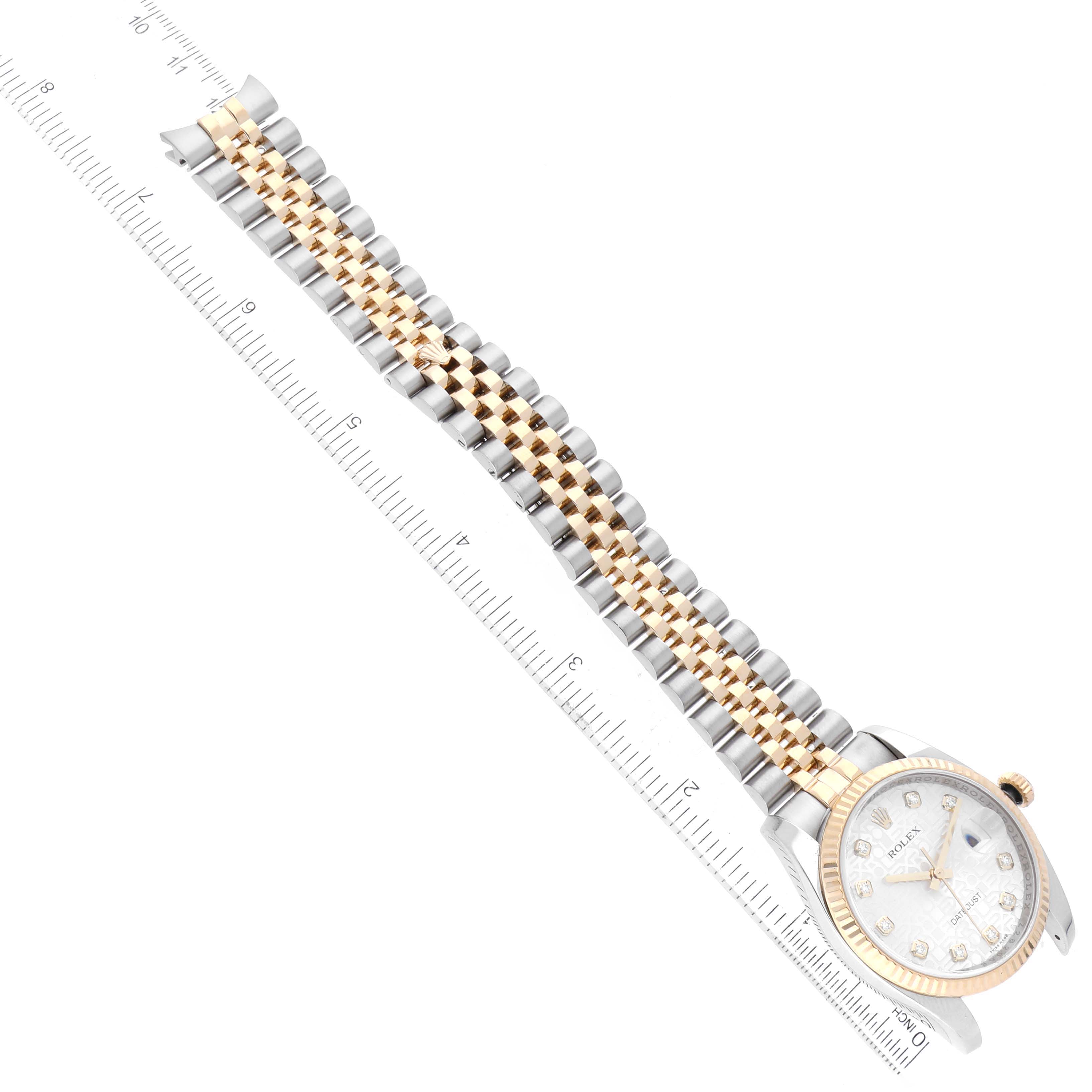 The image shows a Rolex Datejust 116233 Men's Steel and Gold (two tone) Silver Dial 116233 Men's Steel and Gold (two tone) Silver Dial watch at an angled top-down view, highlighting its two-tone bracelet and dial, measured against a ruler.