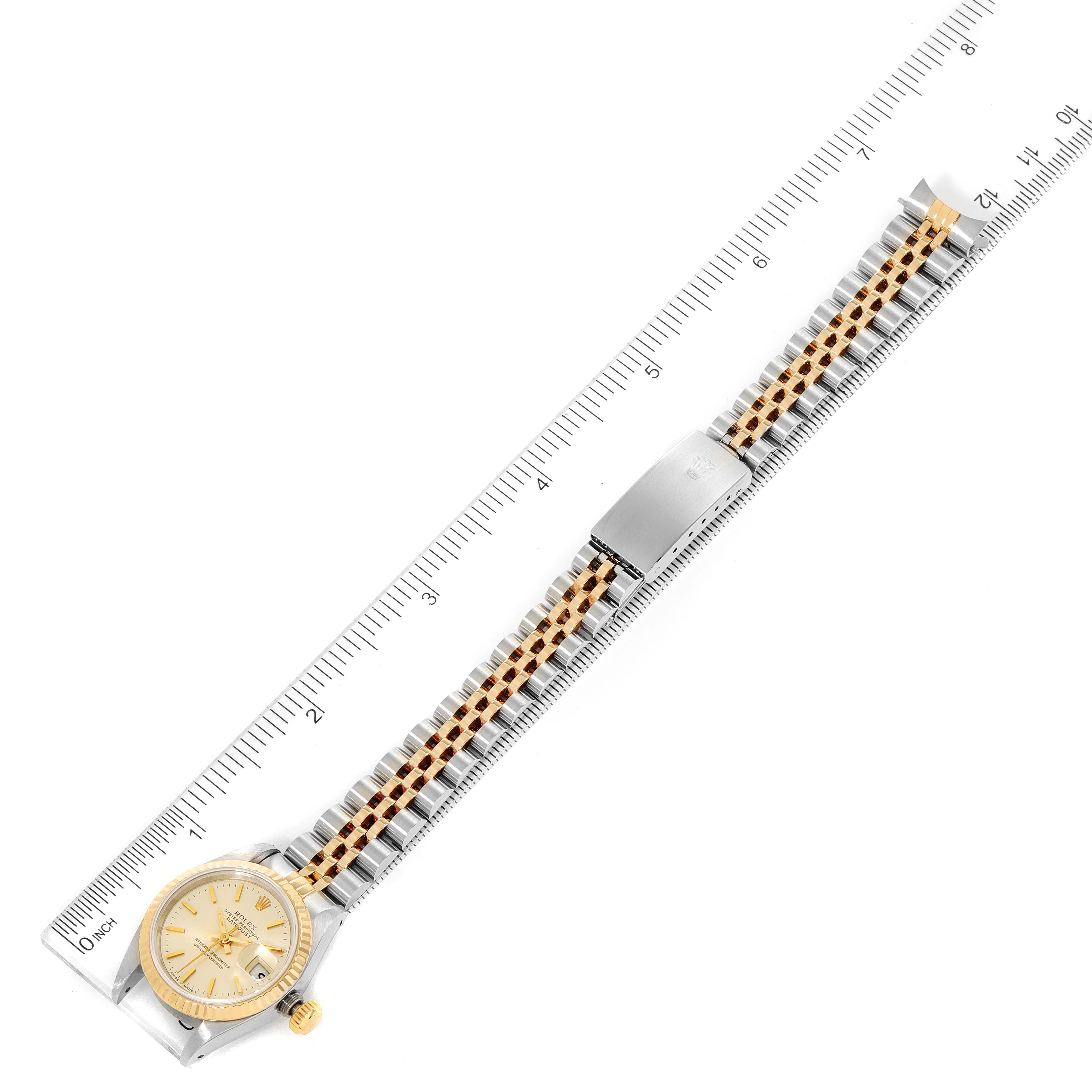 The Rolex Datejust 69173 Women
s Steel and Gold (two tone) Silver Dial 69173 Women
s Steel and Gold (two tone) Silver Dial watch is shown from a top-down angle, including the watch face, bracelet, and clasp.