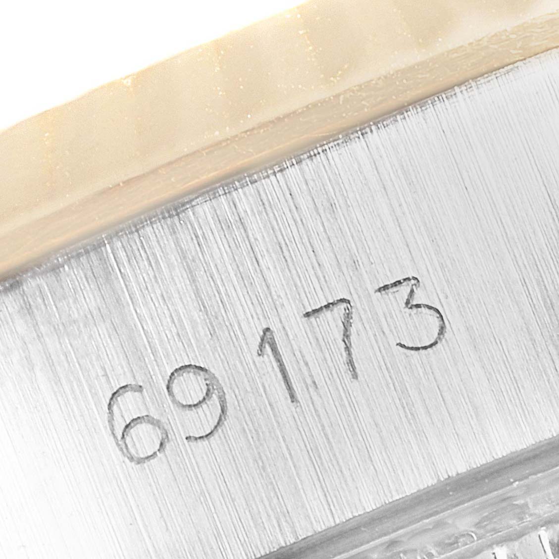 This image shows a close-up of the serial number on the side of the Rolex Datejust 69173 Women
s Steel and Gold (two tone) Silver Dial 69173 Women
s Steel and Gold (two tone) Silver Dial watch case.