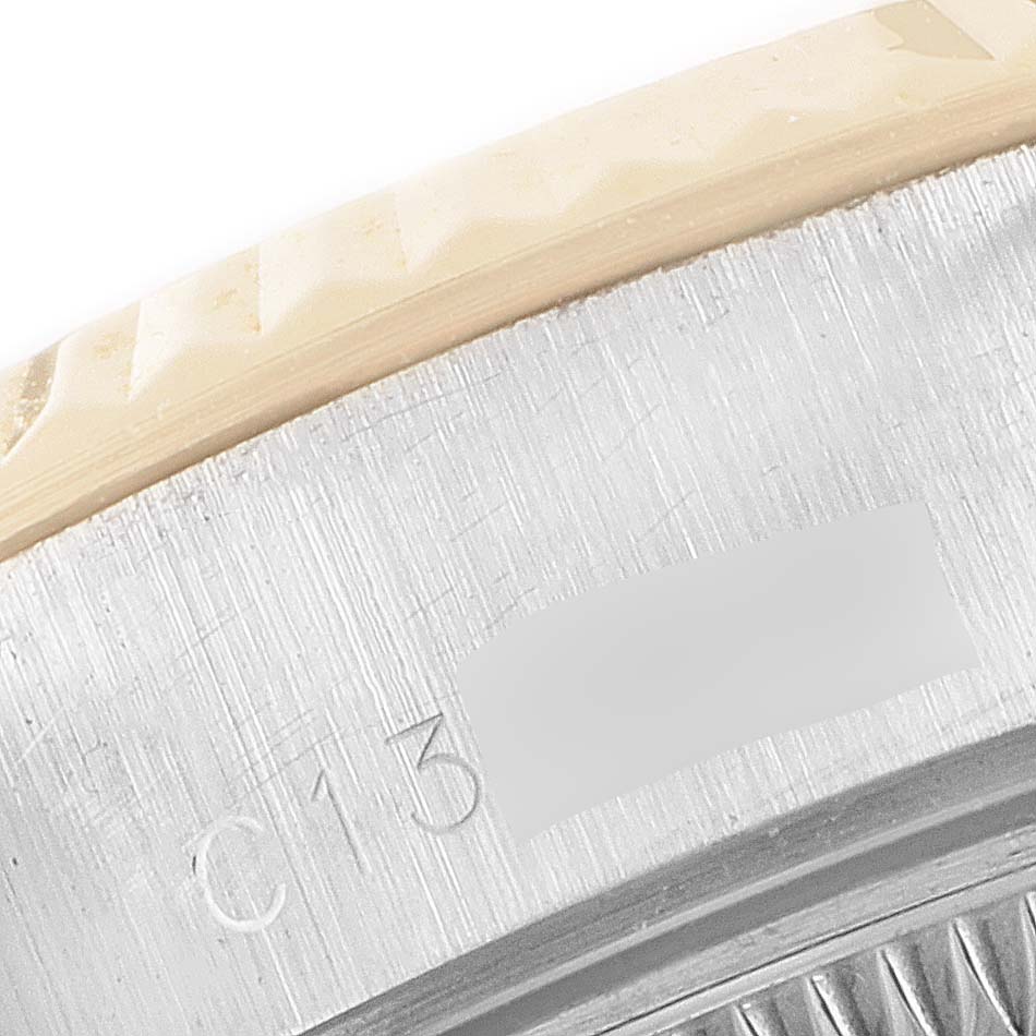 This close-up image displays the serial number engraved on the bezel of a Rolex Datejust 69173 Women
s Steel and Gold (two tone) Silver Dial 69173 Women
s Steel and Gold (two tone) Silver Dial watch.
