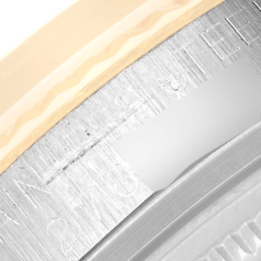 This close-up image shows the serial number and part of the bezel of a Rolex Vintage Collection 16013 Men's Steel and Gold (two tone) Champagne Dial 16013 Men's Steel and Gold (two tone) Champagne Dial watch.
