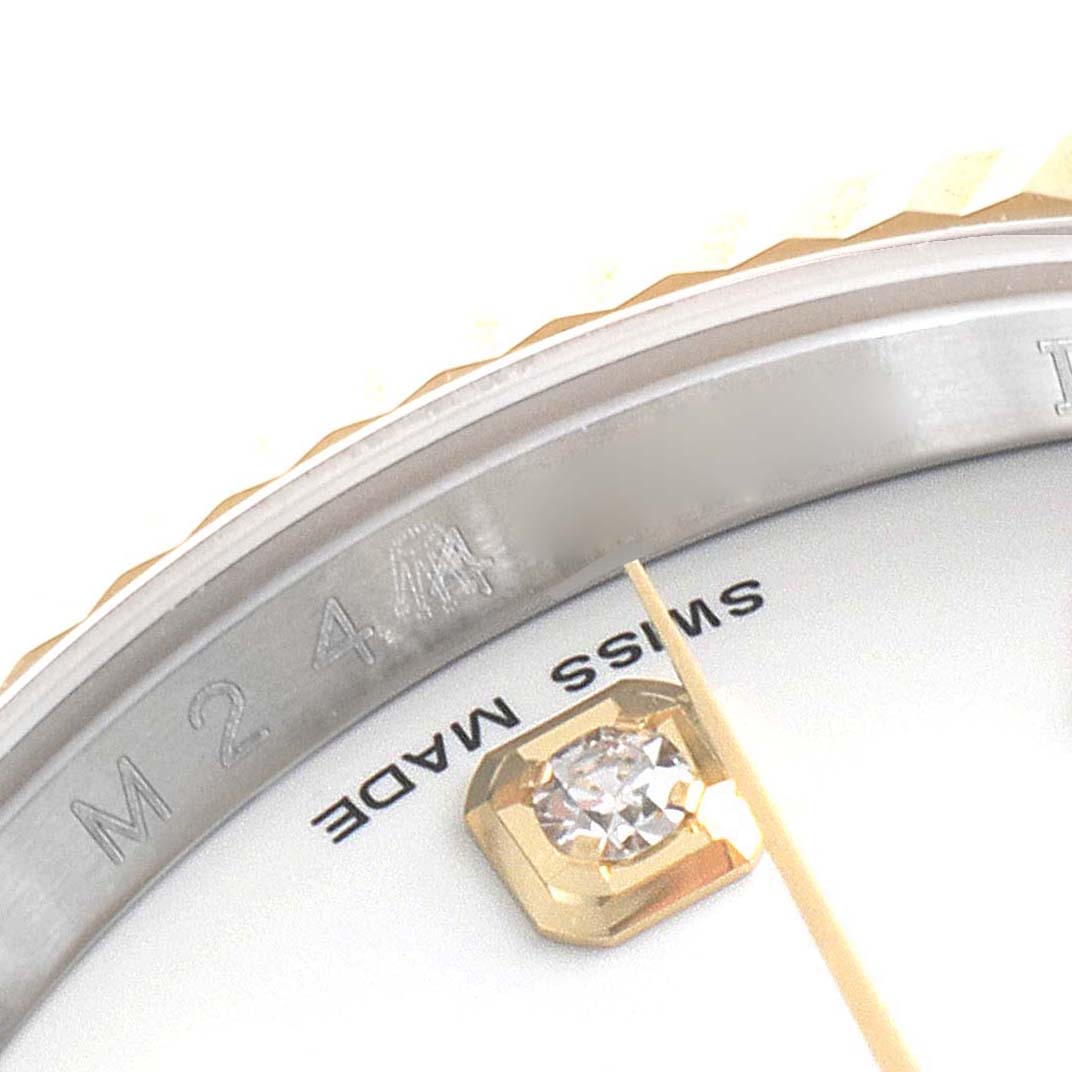 This close-up image features the bezel, part of the dial, and diamond hour marker of a Rolex Datejust 116233 Men's Steel and Gold (two tone) White Dial 116233 Men's Steel and Gold (two tone) White Dial watch.