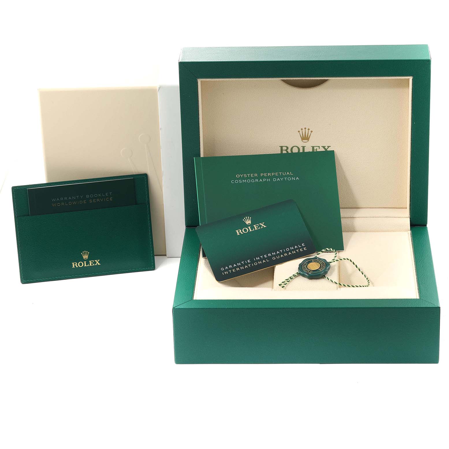 The image shows a Rolex Daytona 116515 Men's Rose Gold Black Dial 116515 Men's Rose Gold Black Dial box and accessories including a warranty booklet, international guarantee card, and a tag.