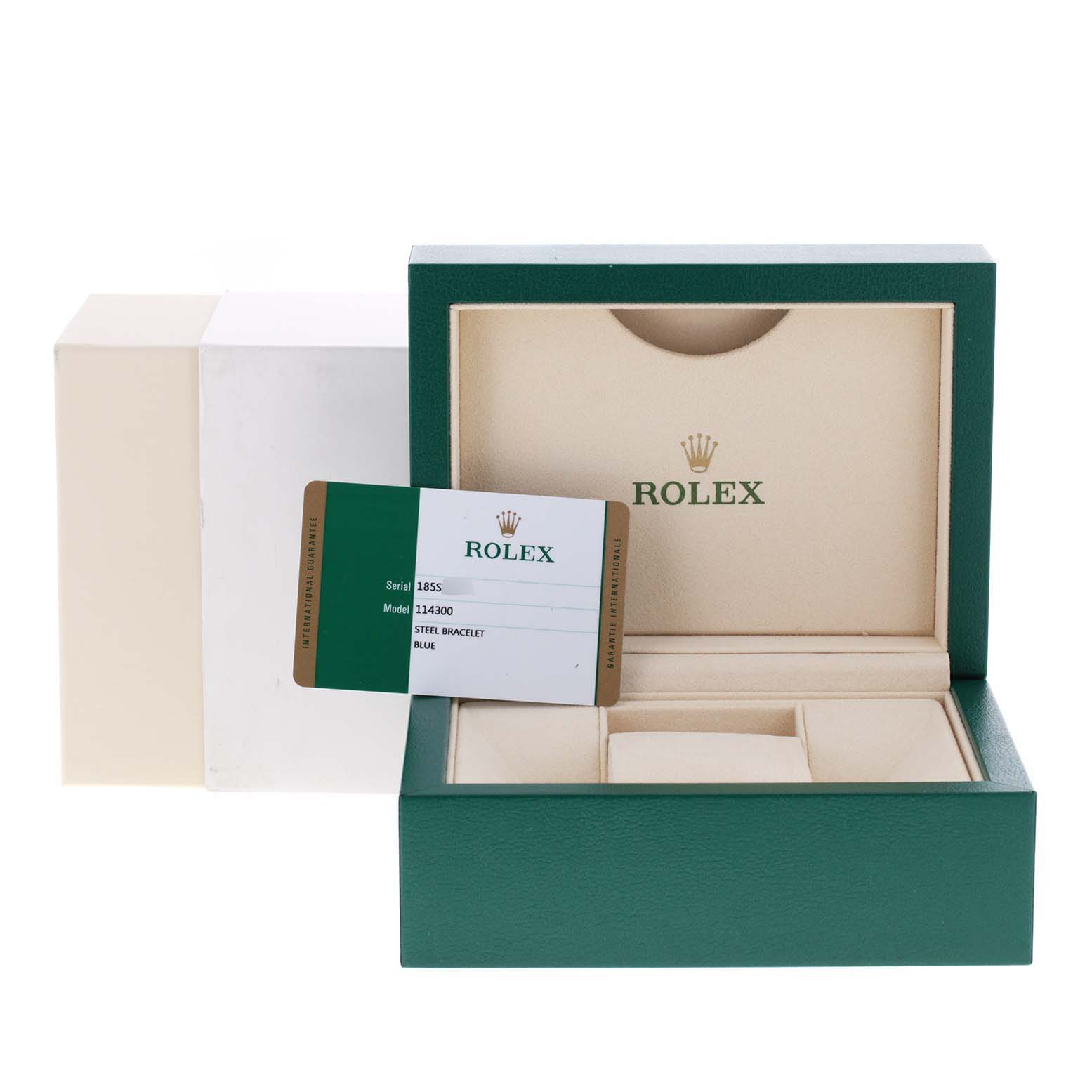 The image shows the packaging and card for a Rolex Oyster Perpetual 114300 Men
s Stainless Steel Blue Dial 114300 Men
s Stainless Steel Blue Dial model, with the watch box open and no watch inside.
