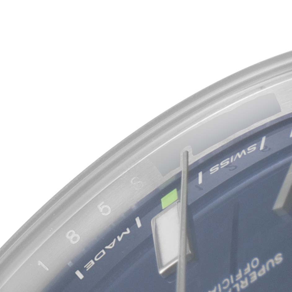 This image shows a close-up of the dial and hands of a Rolex Oyster Perpetual 114300 Men
s Stainless Steel Blue Dial 114300 Men
s Stainless Steel Blue Dial watch.